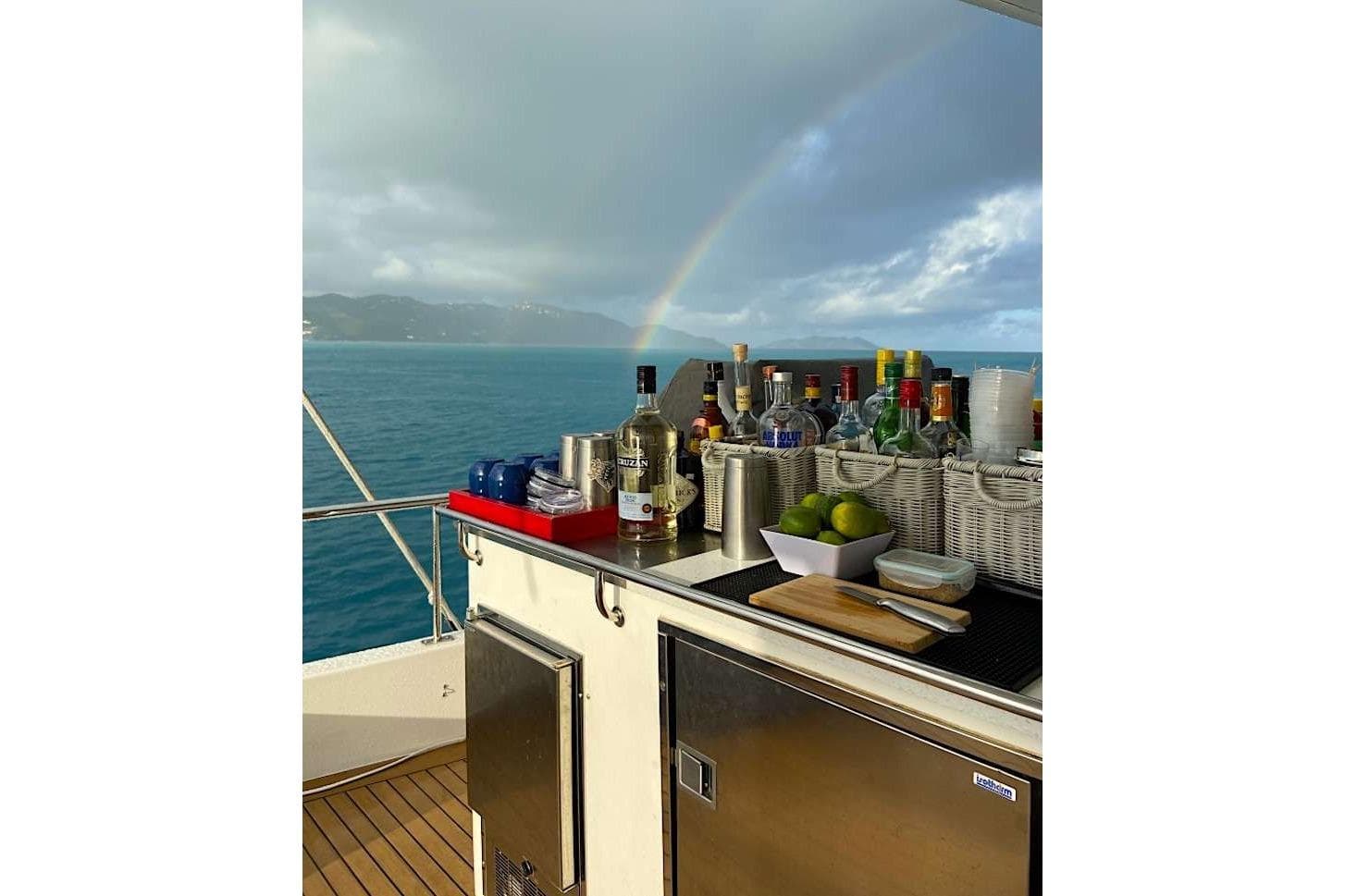 Bar setup on Leopard 58 yacht with ocean view and rainbow, 2014 model.