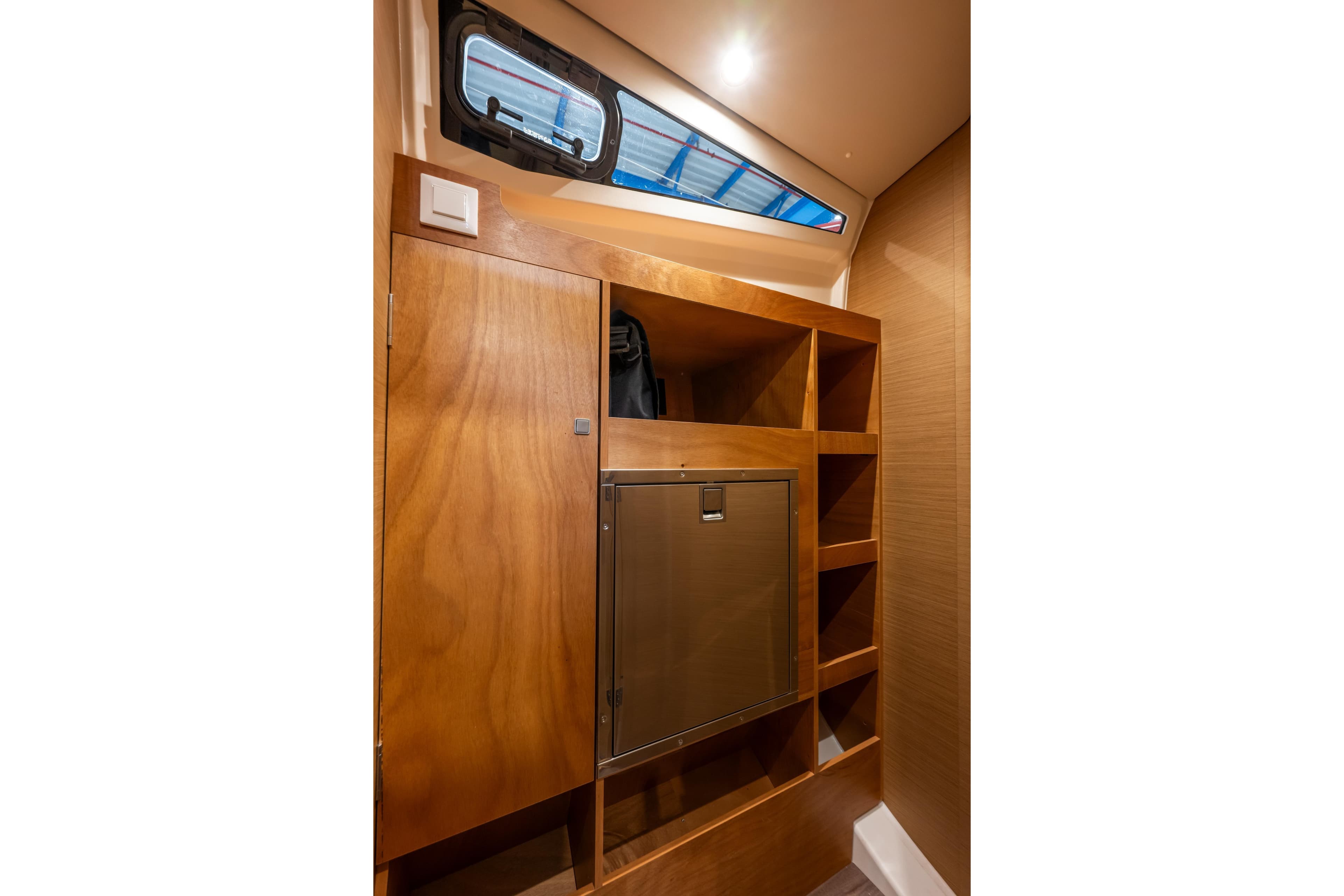 Interior of 2026 Jeanneau Sun Odyssey 455 yacht with wooden cabinetry and storage.