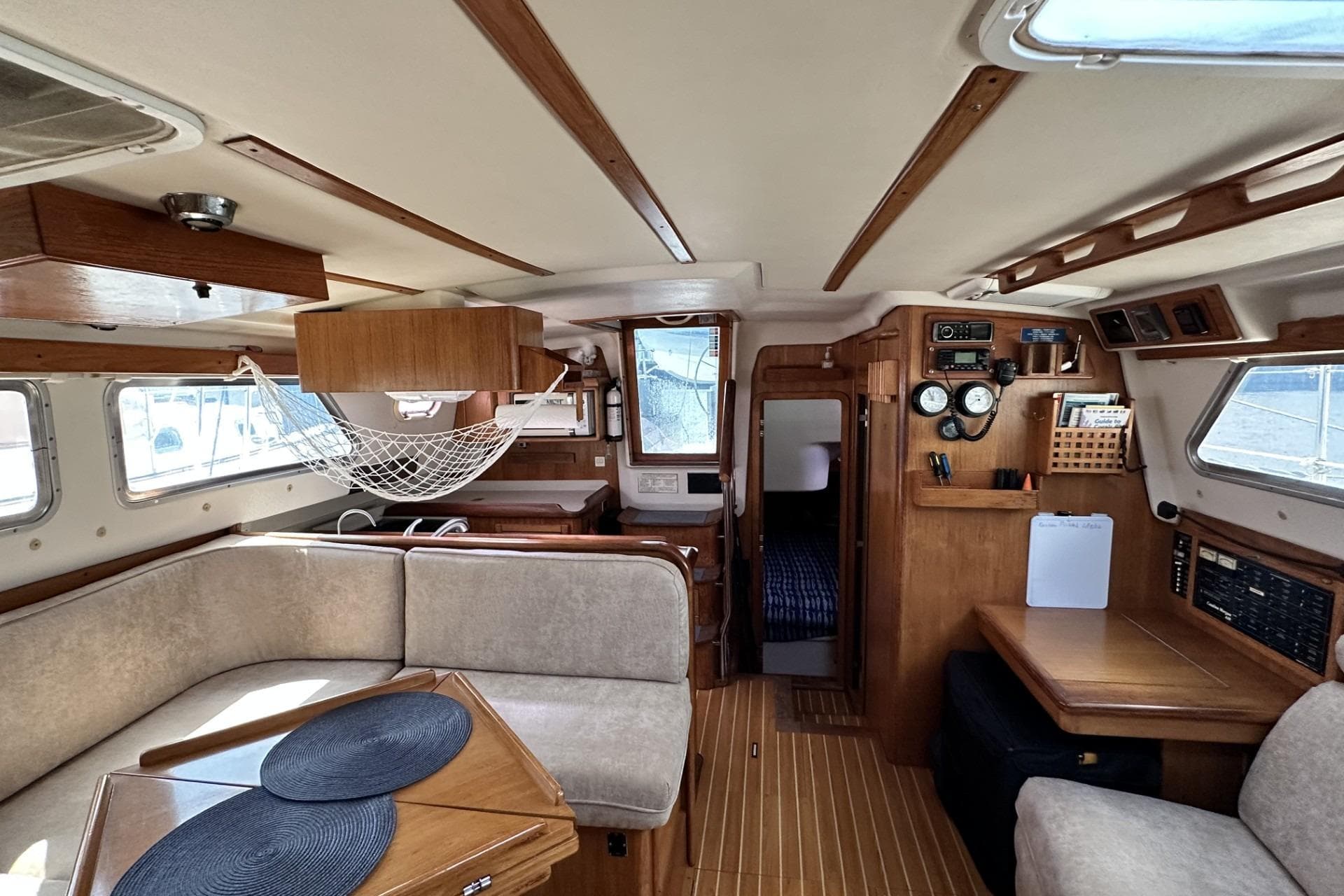 Interior of 2005 Catalina Morgan 440 yacht with cozy seating and wooden accents.