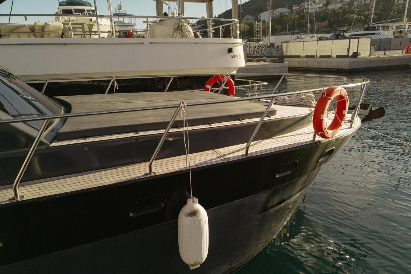 Custom Made 40 yacht docked at marina, featuring life rings and fenders, 2019 model.