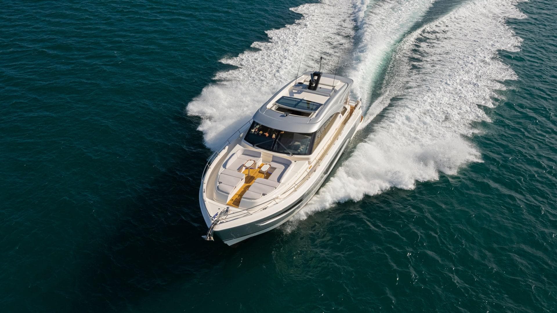 2025 Riviera 6800 Sport Yacht Platinum Edition cruising on open water.