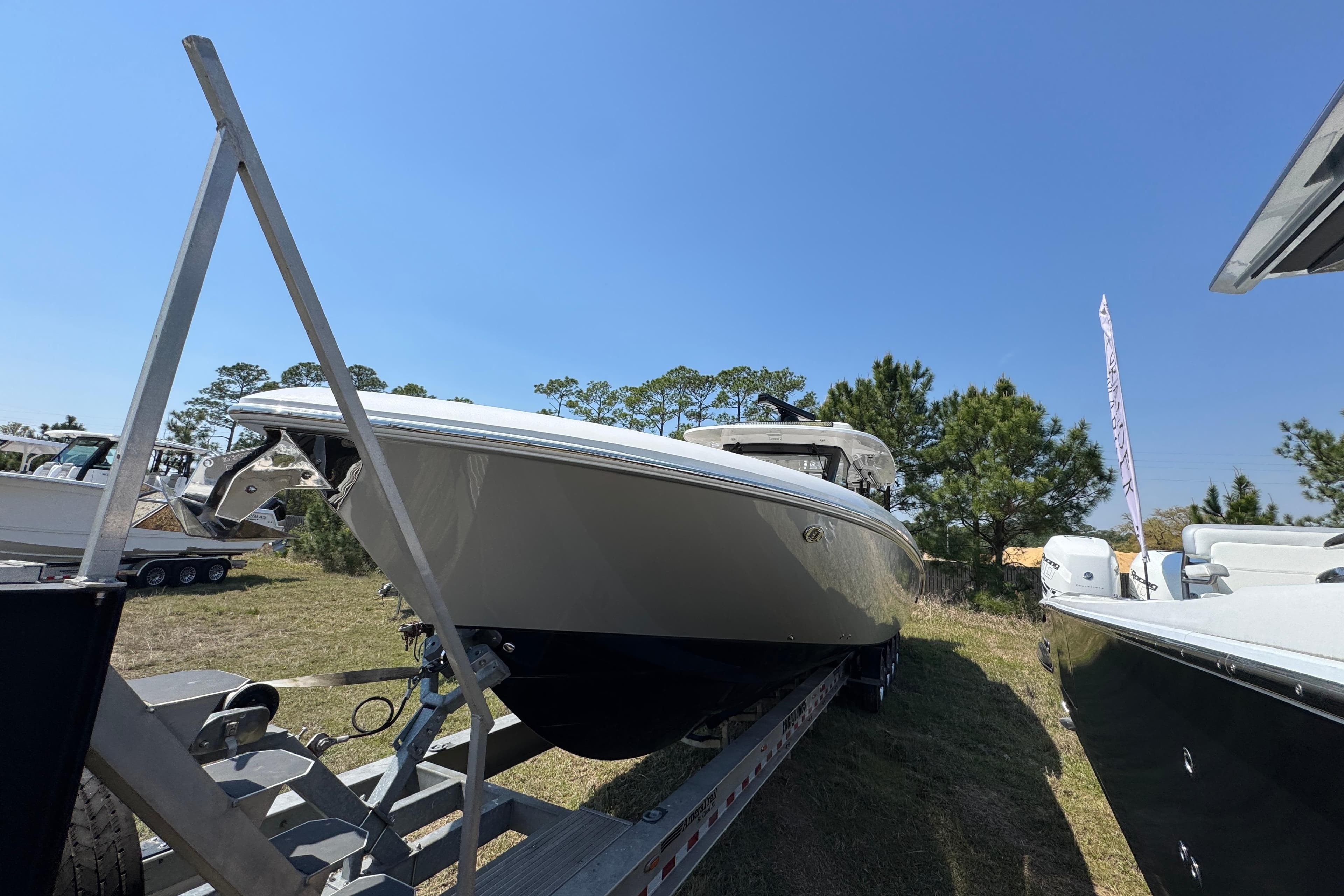 2019 Everglades 435 Center Console boat on trailer, displayed outdoors under clear blue sky.