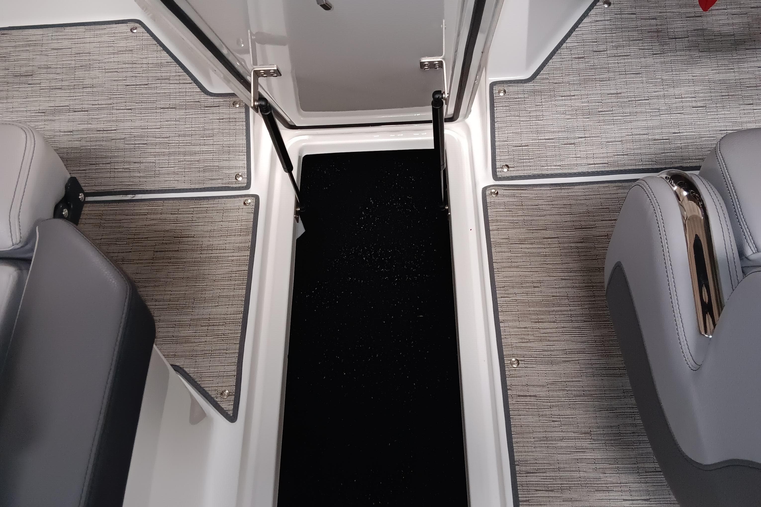 2023 Cobalt R4 boat interior with gray seating and textured flooring.