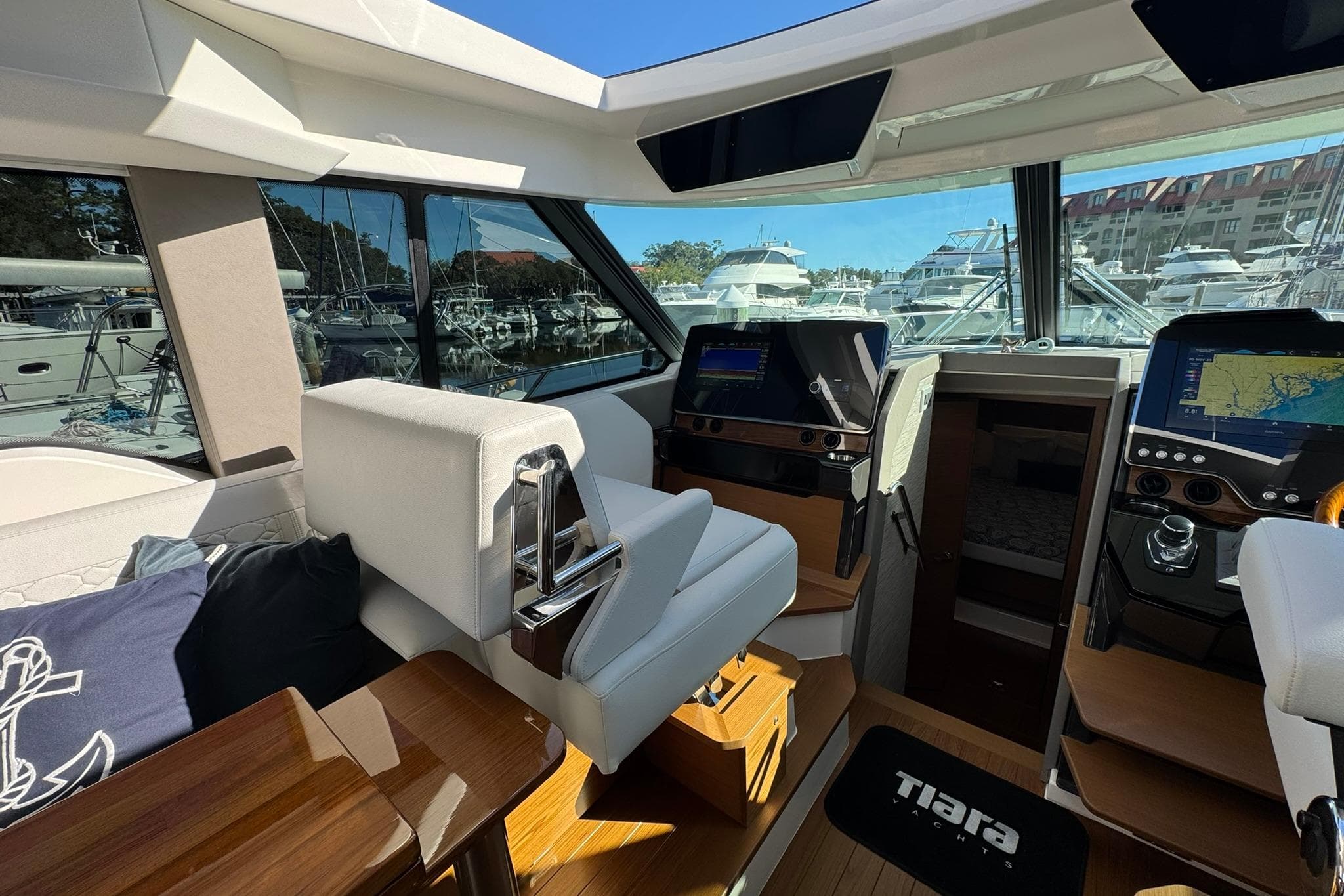 Interior of 2025 Tiara Yachts 43 LE, featuring modern navigation displays and luxurious seating.