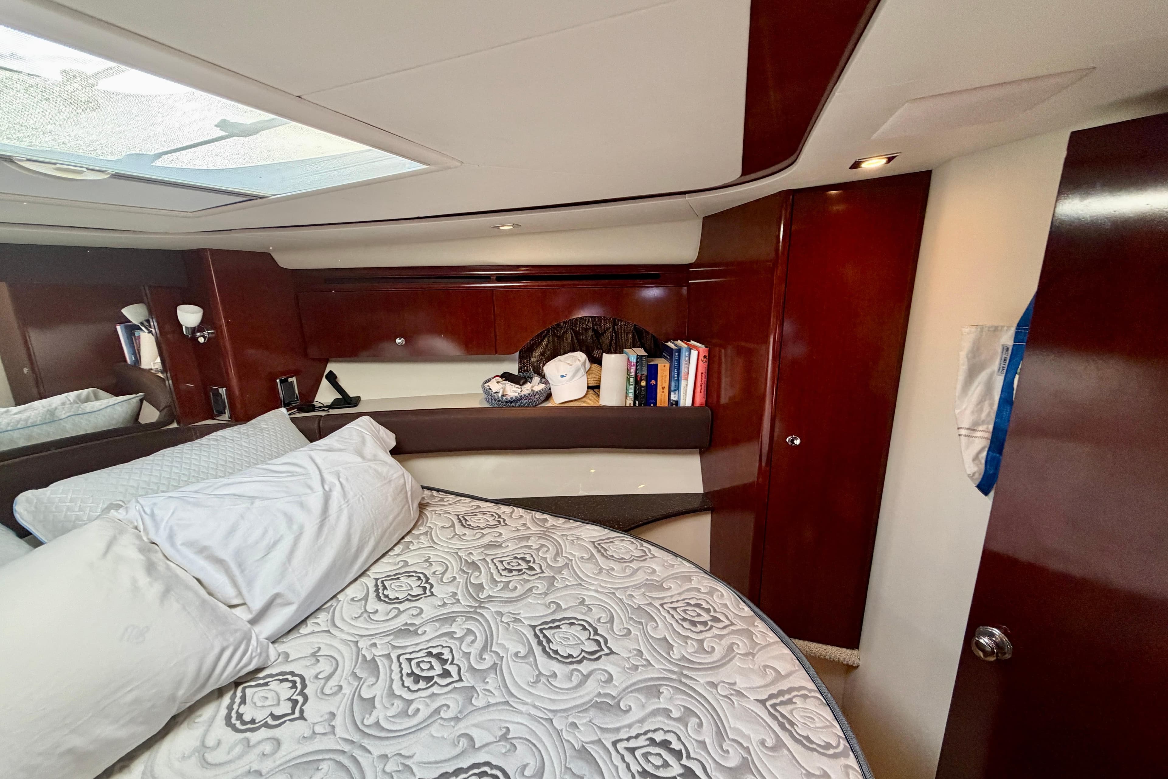 Luxurious cabin interior of 2011 Meridian 441 Sedan yacht with elegant wood finish.