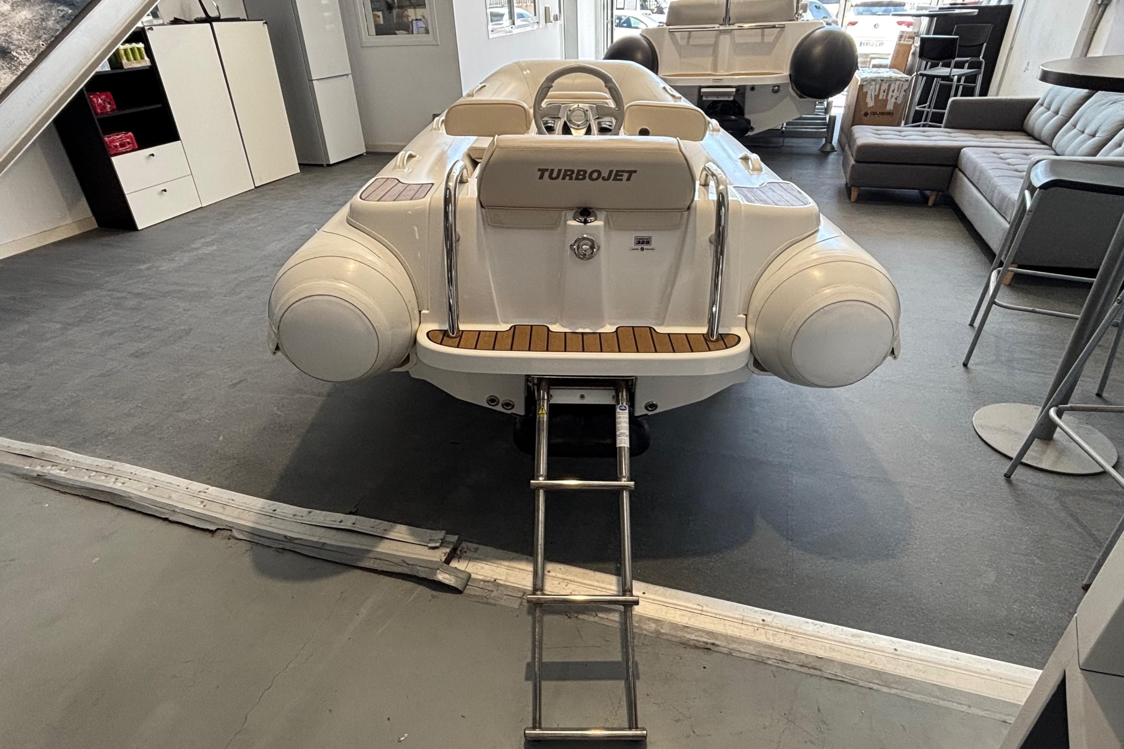 2014 Williams Jet Tenders Turbojet 325 displayed indoors with ladder access.