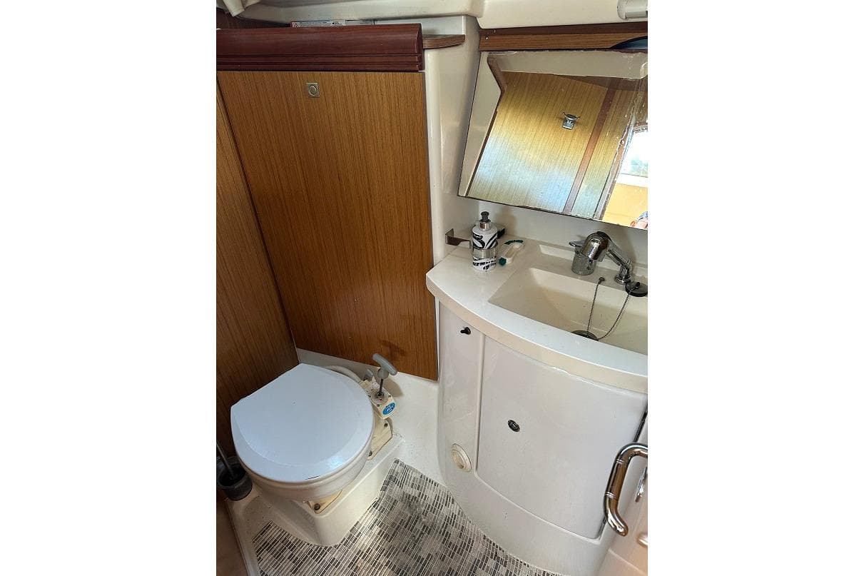 Bathroom interior of 2008 Jeanneau Sun Odyssey 39i yacht, featuring toilet and sink.