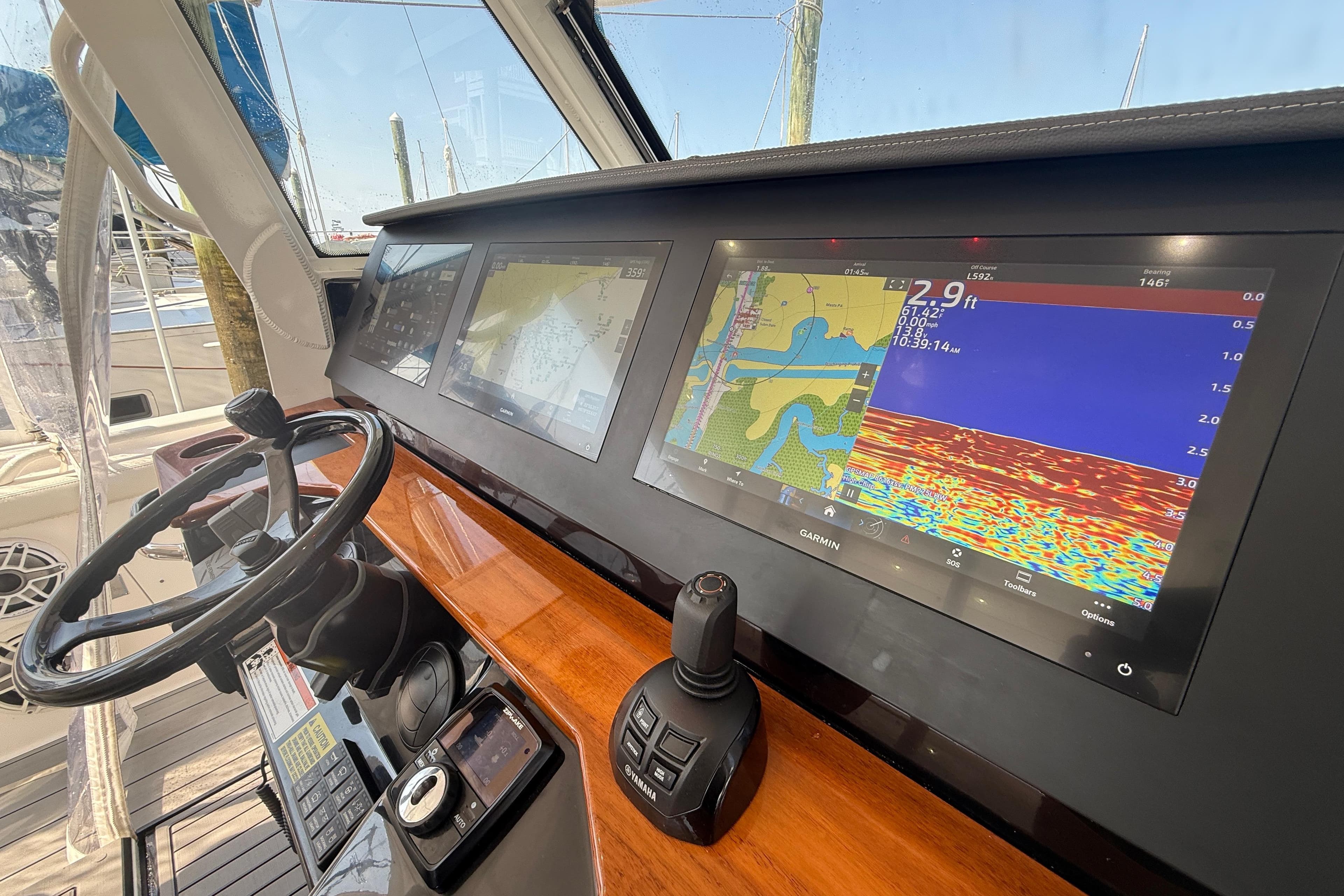Dashboard of 2021 Everglades 395 Center Console with navigation screens and controls.