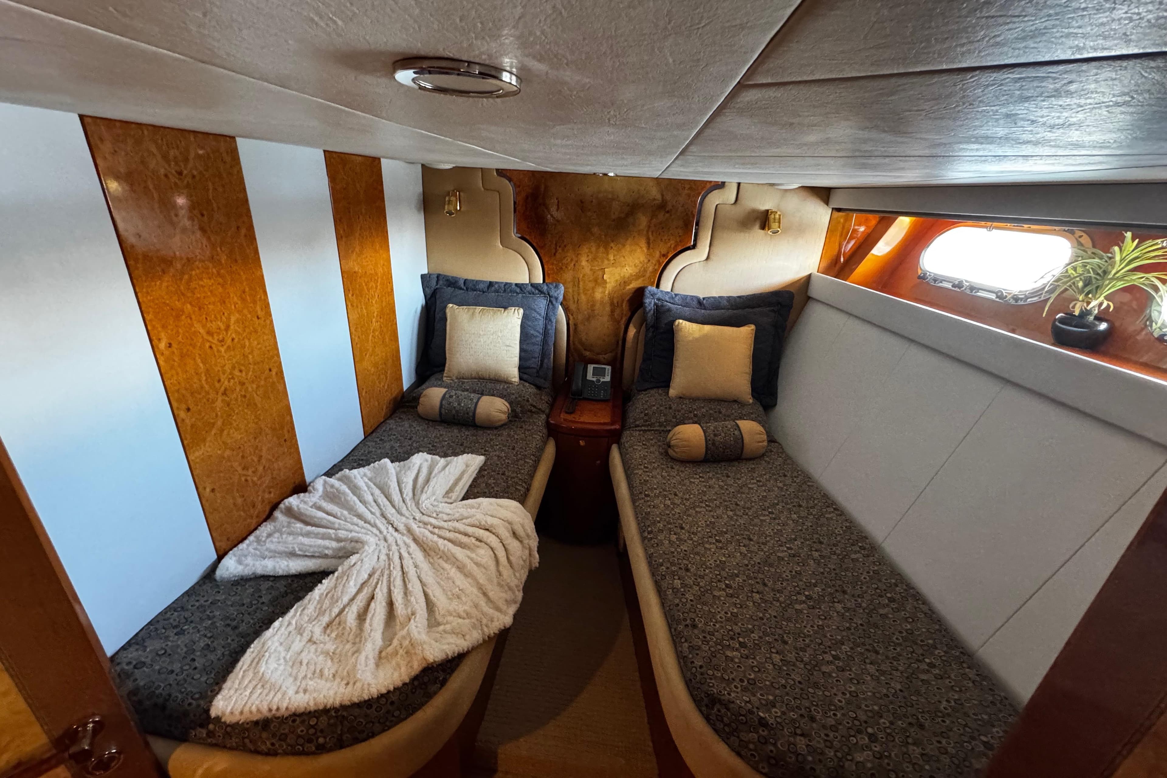 Luxurious cabin interior of 1996 Hershine Benship 87 yacht with twin beds and elegant decor.