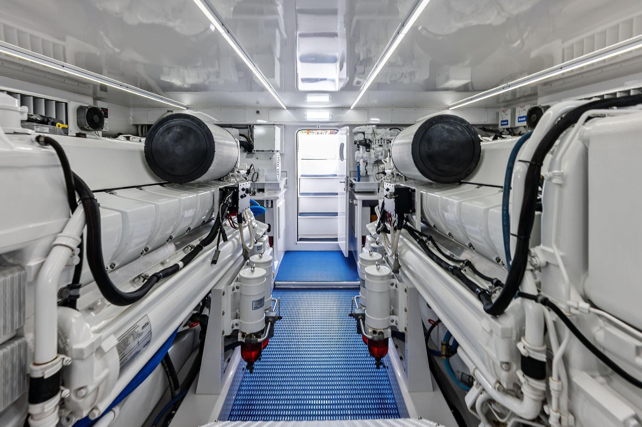 Engine room of a 2017 Weaver Custom Sportfish boat, featuring dual engines and modern equipment.