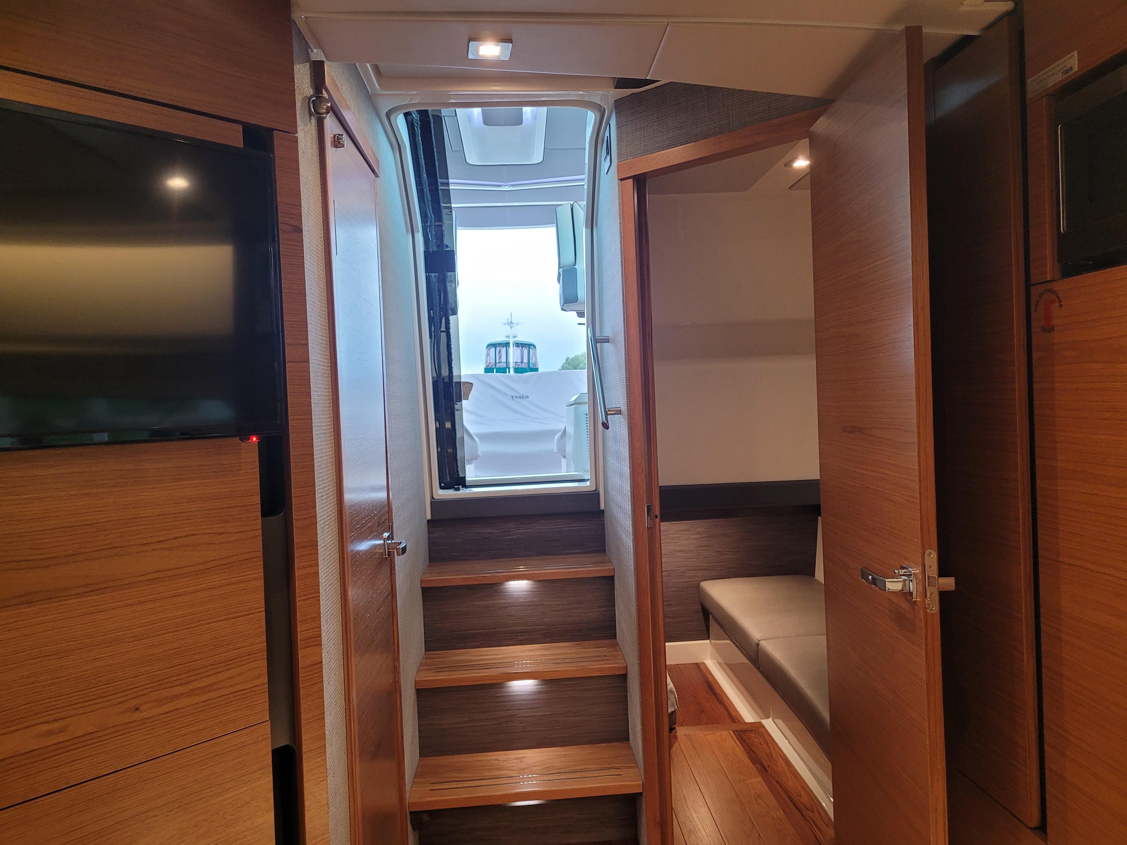 Interior view of 2021 Tiara Sport 43LE yacht, featuring wooden stairs and modern design.