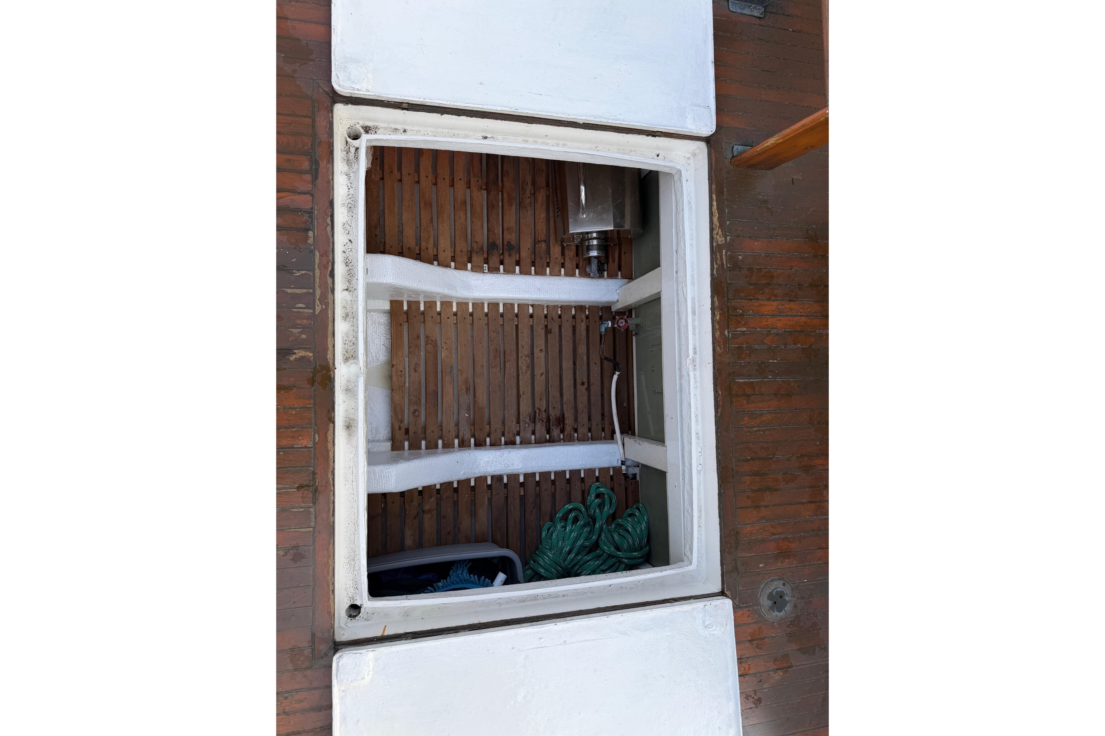 Storage compartment of a 1981 Grand Banks 32 Sedan boat with ropes and equipment.