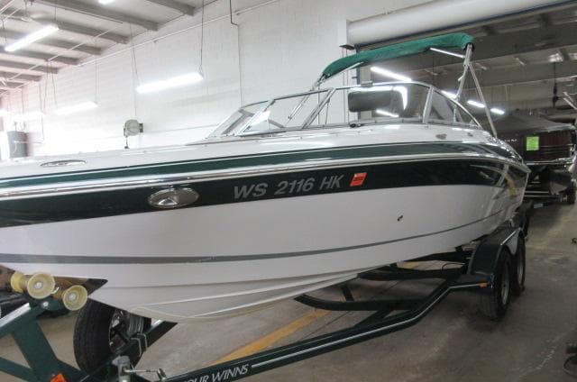 2007 Four Winns 220 Horizon boat on trailer in indoor storage.