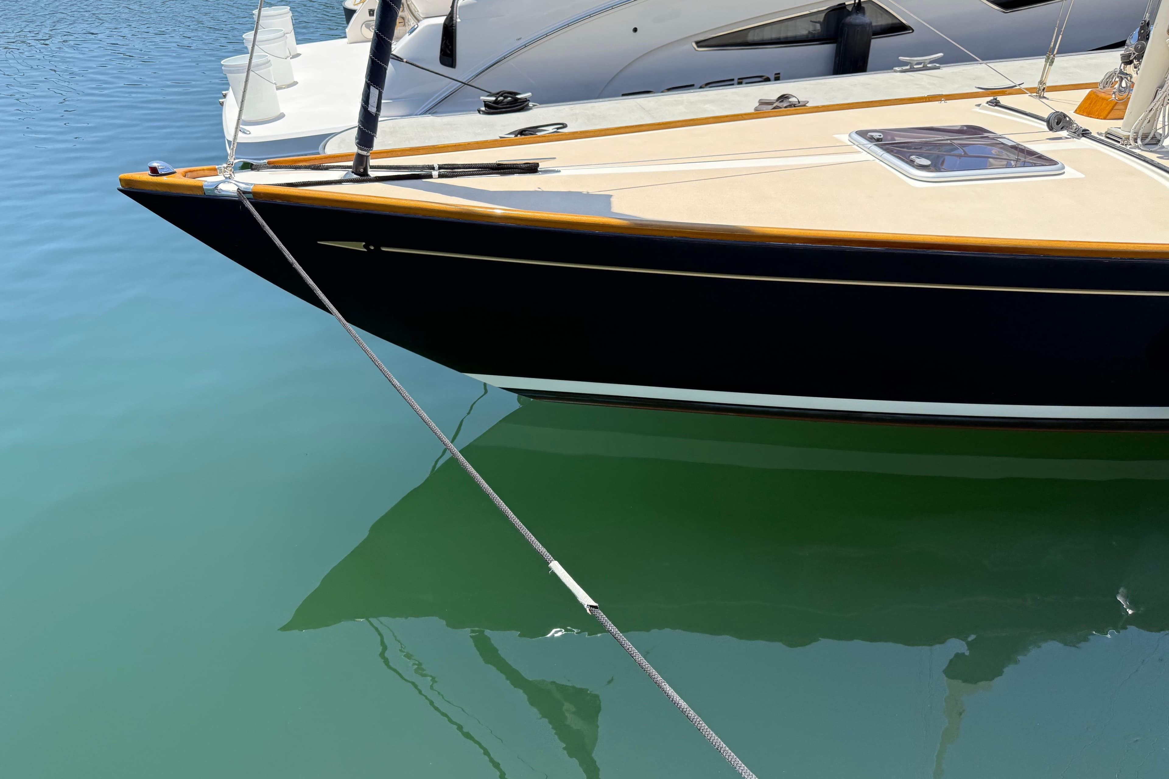 Sleek 2012 Morris M29 yacht docked on calm blue water.