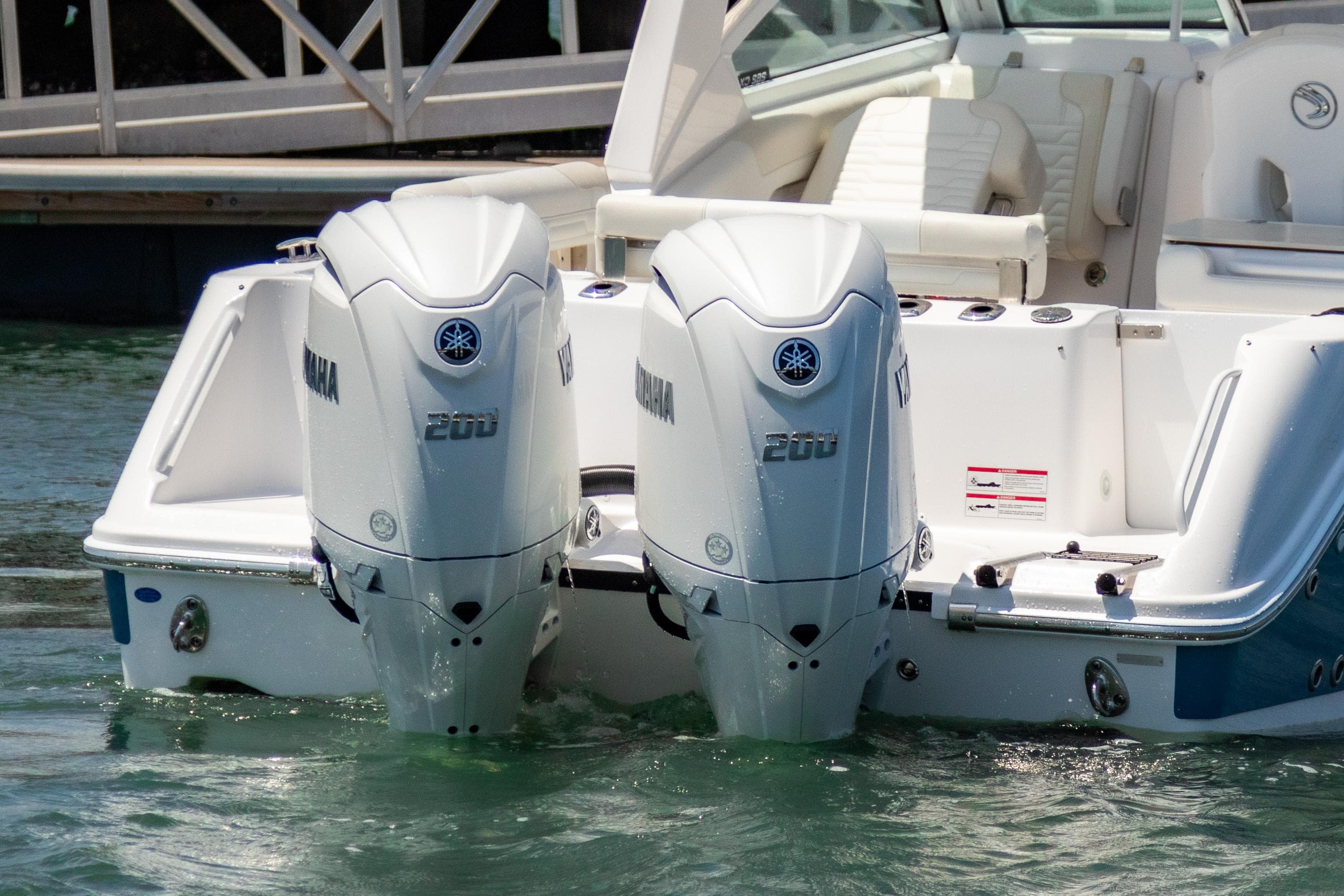2025 Edgewater 262 CX boat with dual Yamaha 200 outboard engines in water.