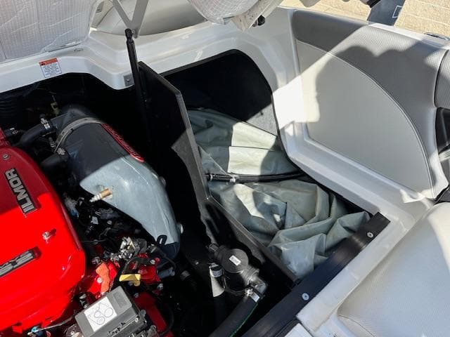 2016 MasterCraft X46 engine compartment with Ilmor engine and storage area.