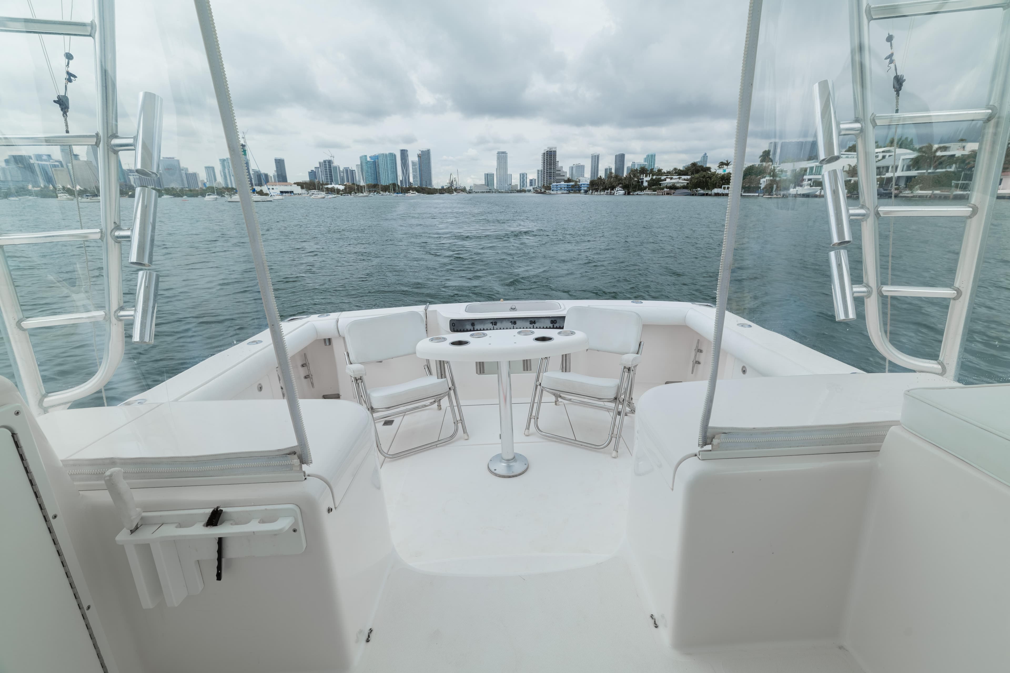 2006 Cabo 35 Express boat with city skyline view, featuring spacious deck and seating.