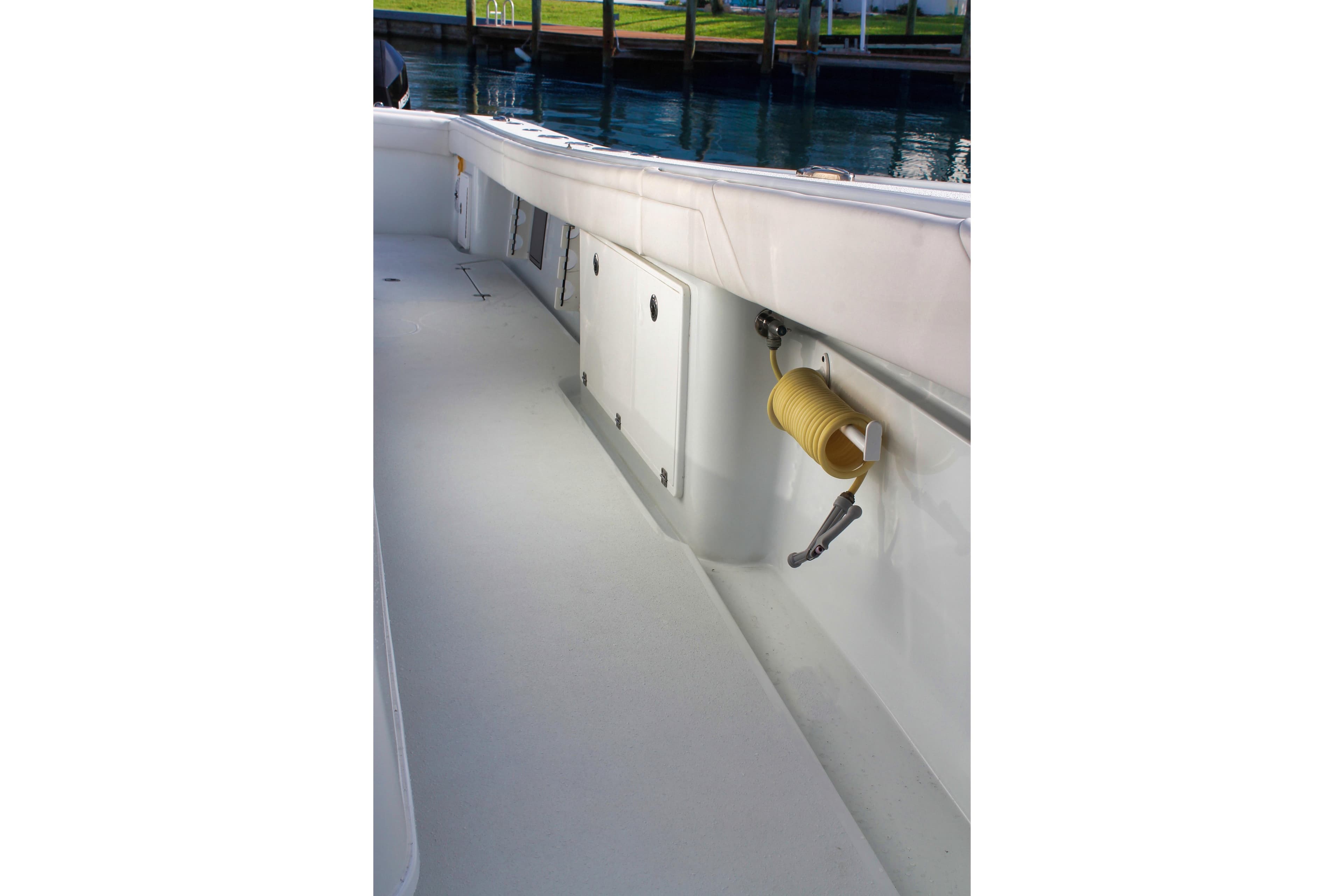 2022 Yellowfin 39 Offshore boat deck with coiled hose and storage compartments.