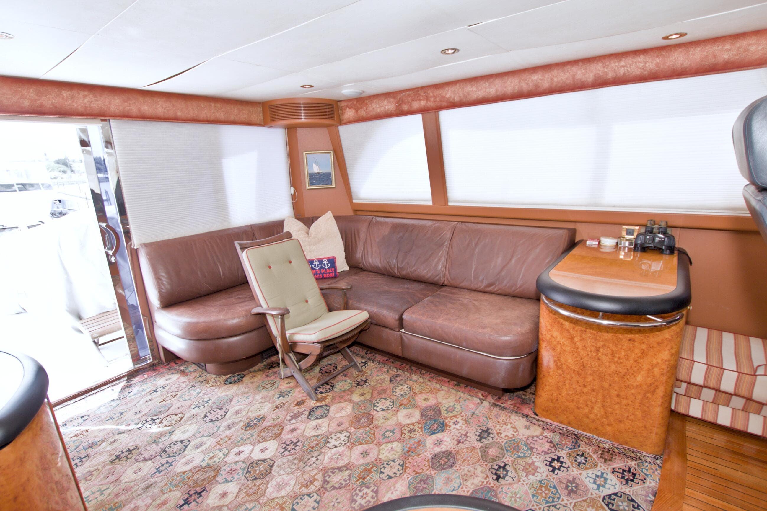 Luxurious interior of 1998 Lazzara 76 Skylounge Grand Salon yacht with leather seating and elegant decor.