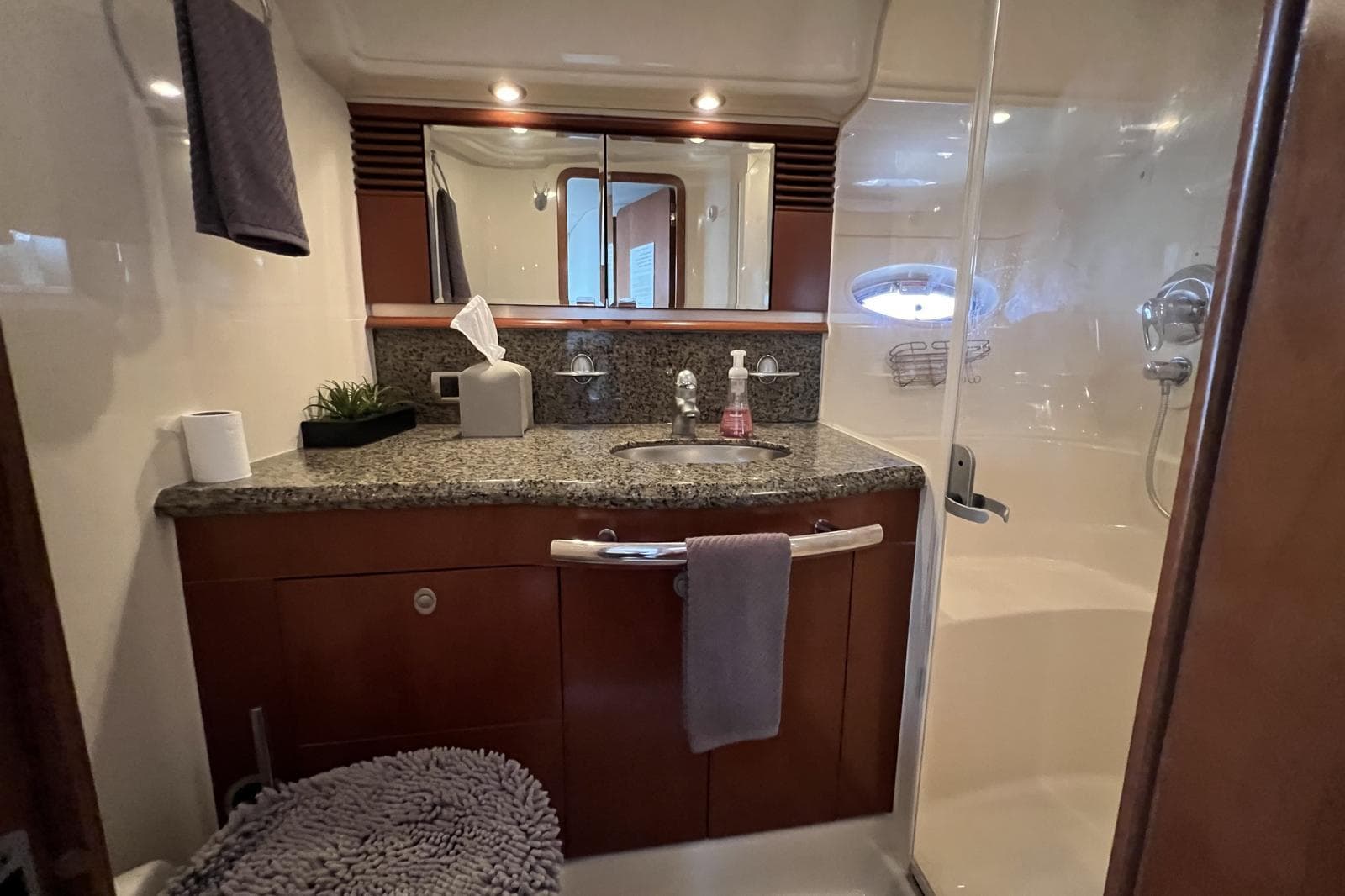 Luxurious bathroom in 2005 Sea Ray 500 Sundancer yacht with granite countertop and shower.
