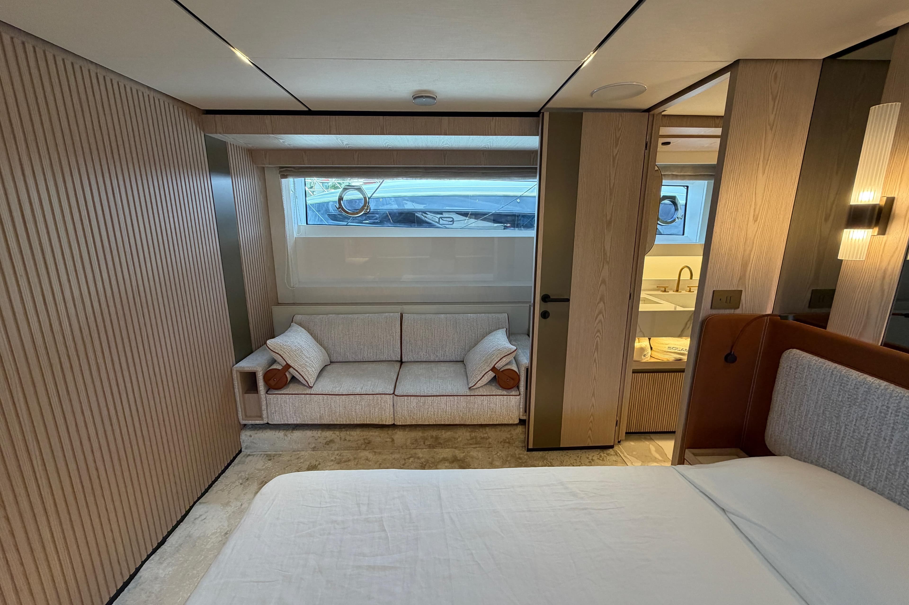 Luxurious interior of 2028 Solaris Power 70 Long Range yacht, featuring elegant wood paneling and cozy seating.