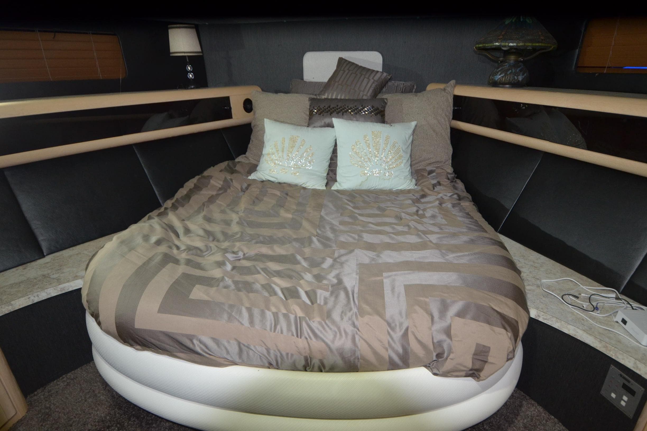 Luxurious bedroom interior of 1989 Silverton 46 Aft Cabin yacht with elegant bedding.