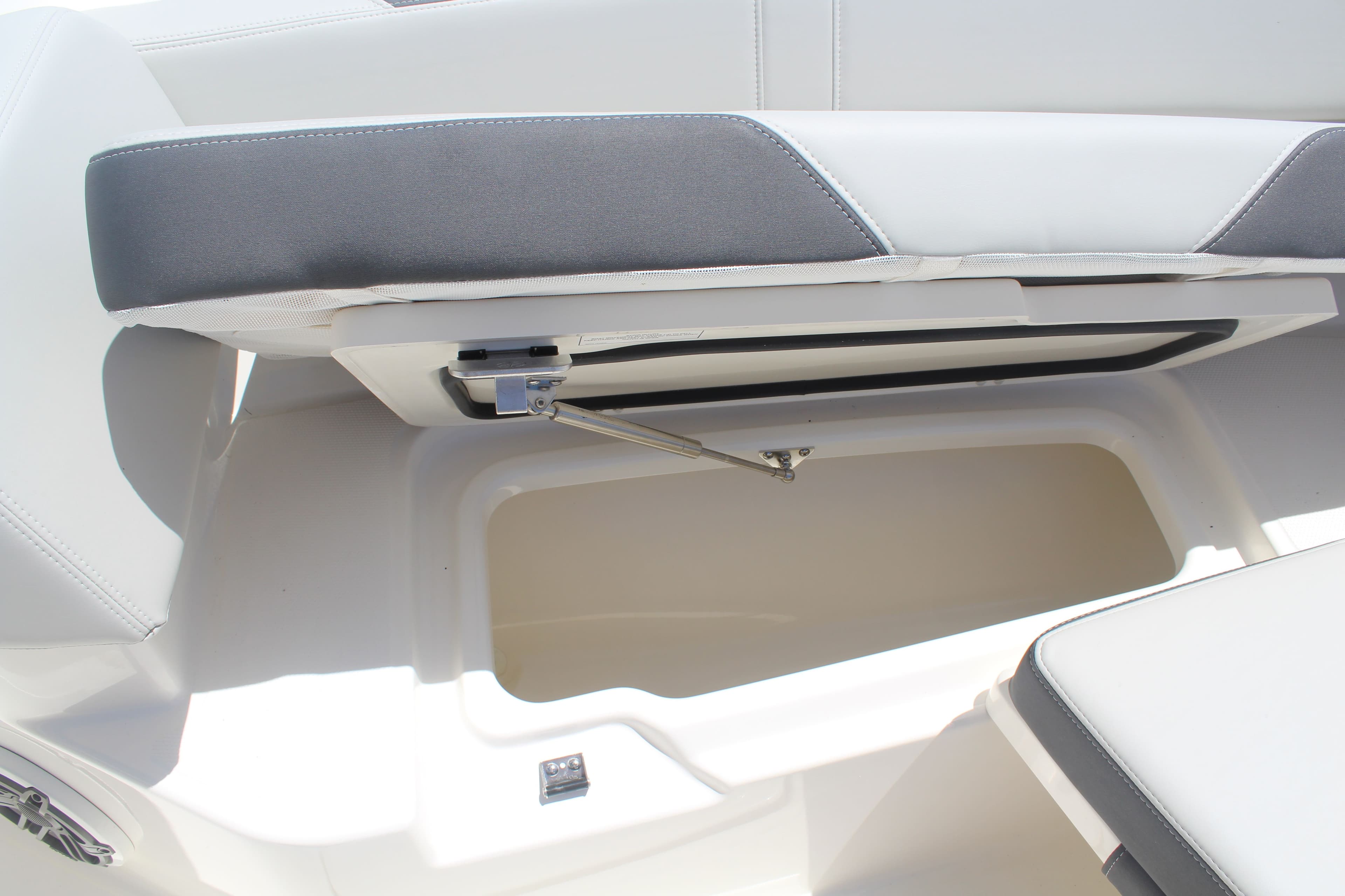 Boston Whaler 330 Outrage 2026 seat with storage compartment.