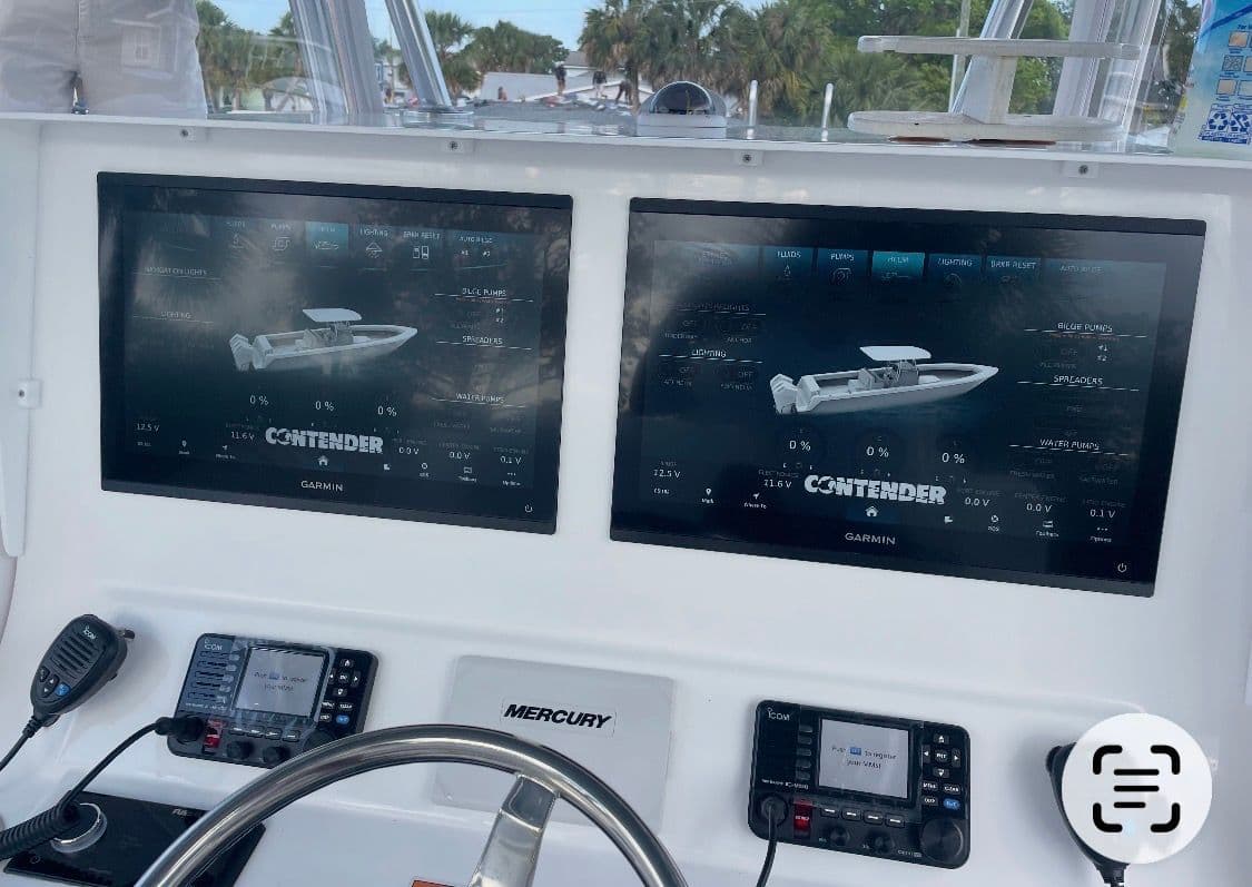 2025 Contender 39 ST boat dashboard with dual Garmin displays.