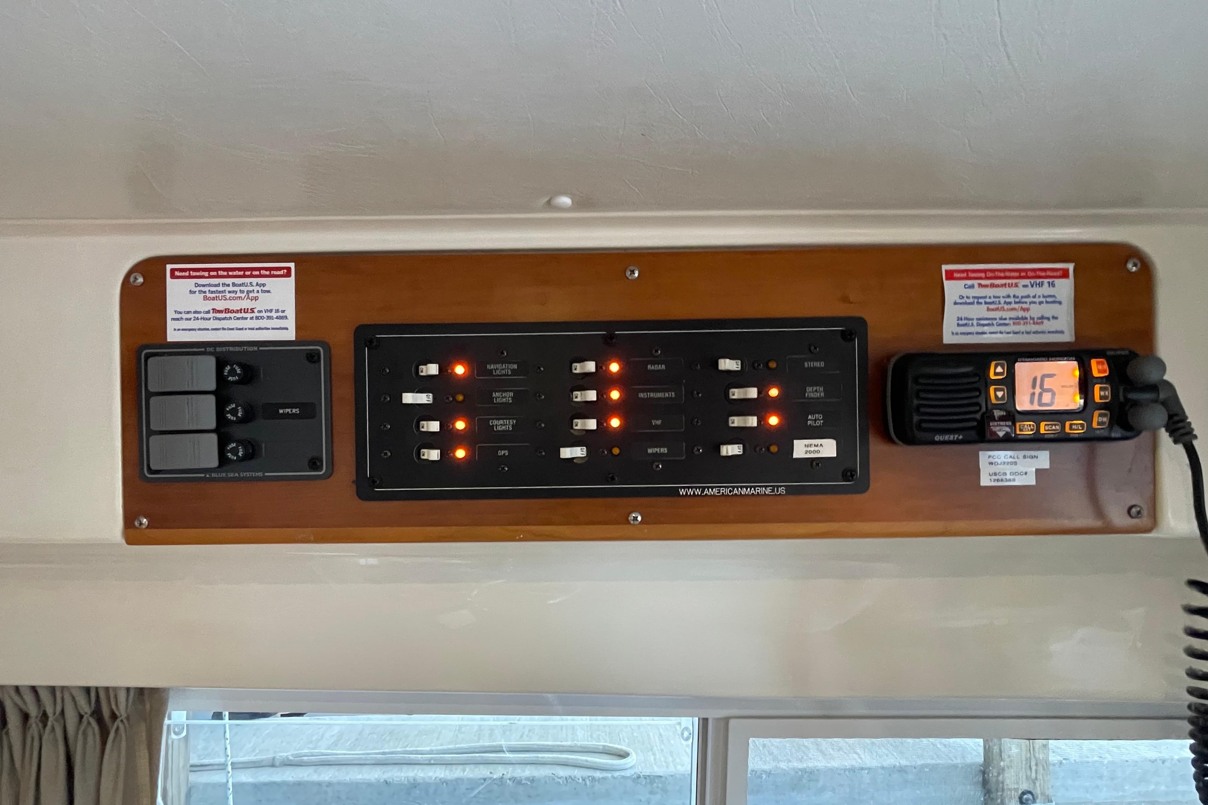Control panel of 2006 PDQ 34 Power Catamaran with switches and radio display.