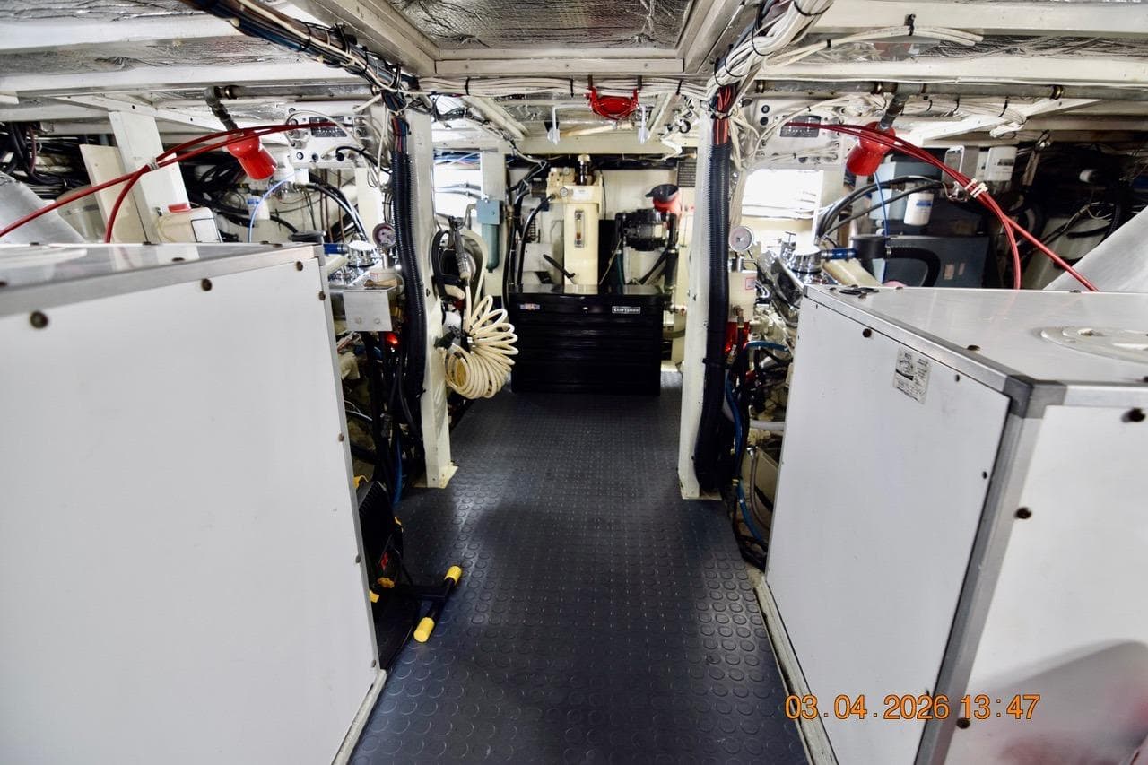 Engine room of a 1976 Hatteras 48 Long Range Cruiser, showcasing machinery and equipment.