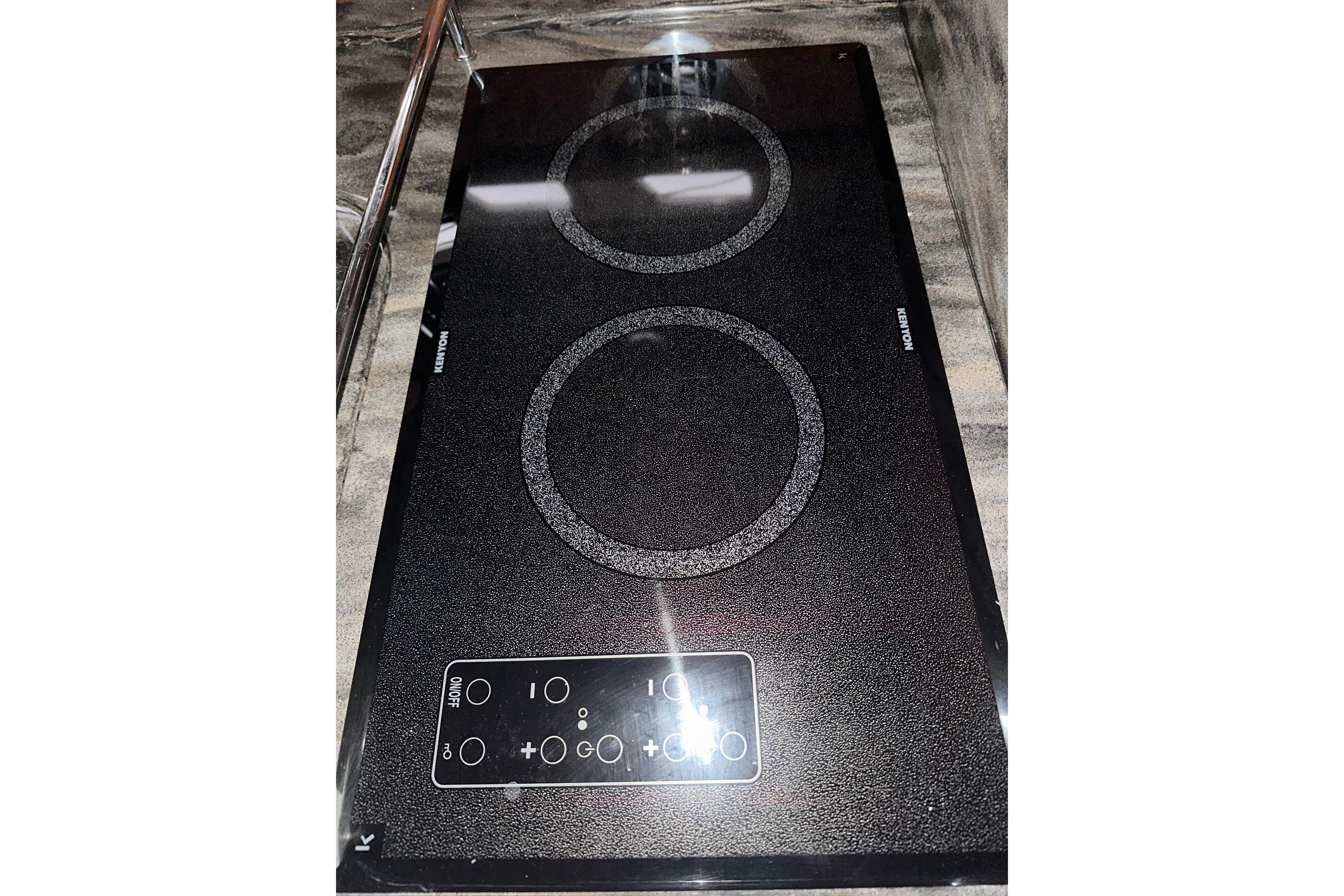 Ceramic cooktop on 2012 Sea Ray 390 Sundancer yacht, featuring dual burners and touch controls.
