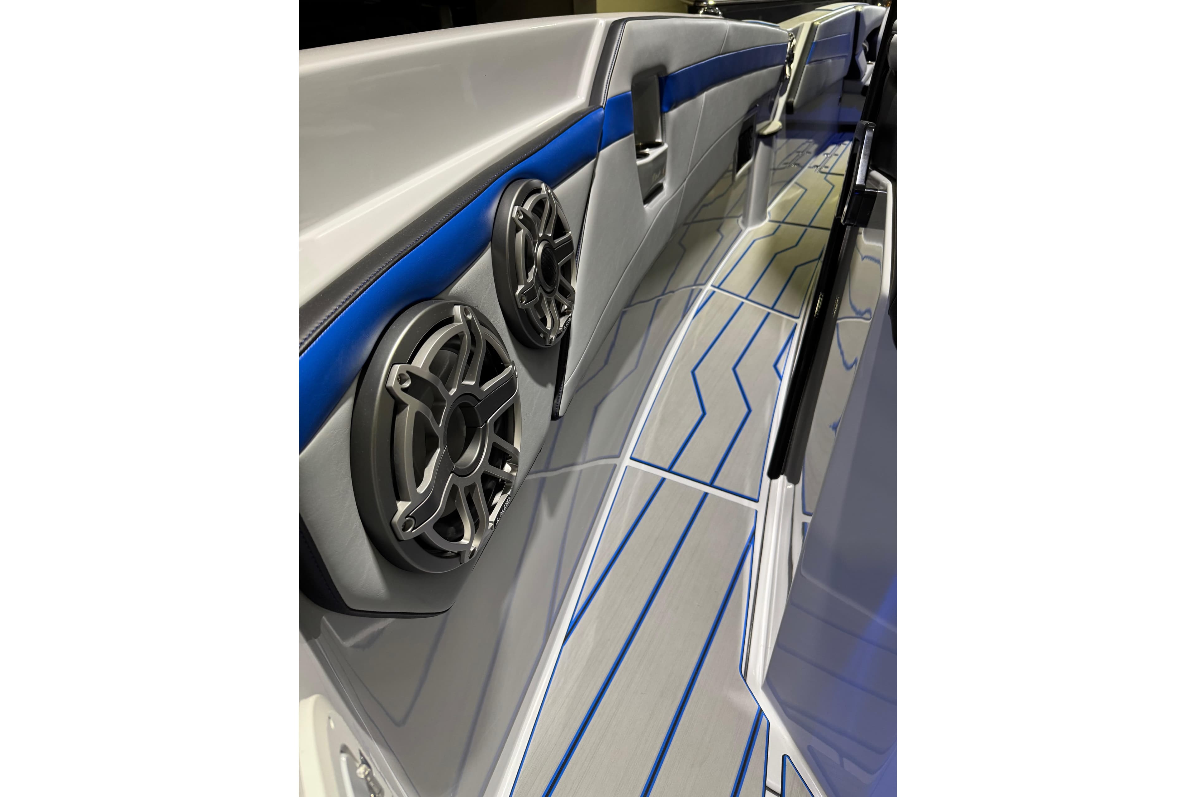 2025 Sunsation 32 CCX boat interior with sleek design, blue accents, and modern speakers.