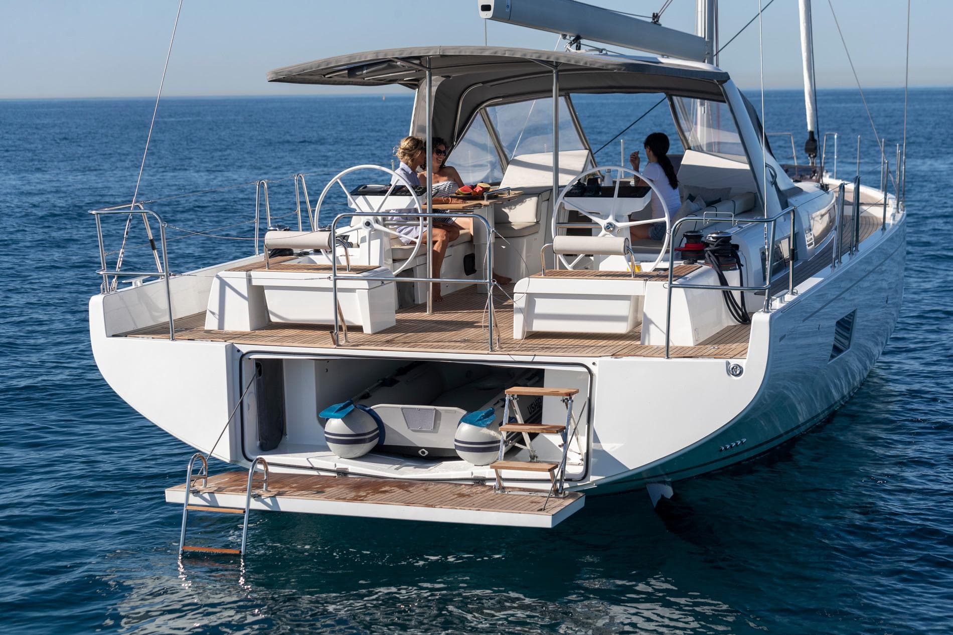 2025 Beneteau Oceanis Yacht 54 sailing on open water, rear view.