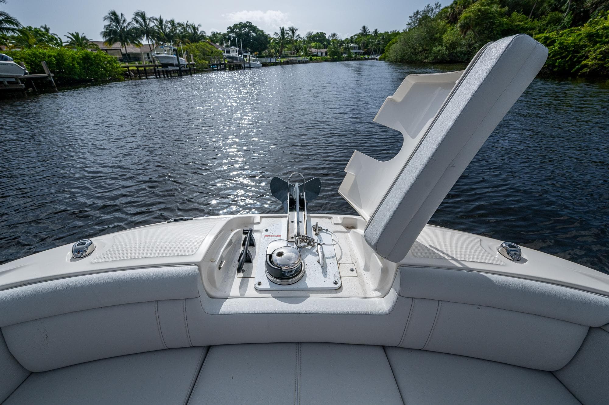 2022 Sea Ray SDX 290 boat with open anchor hatch on a calm river.
