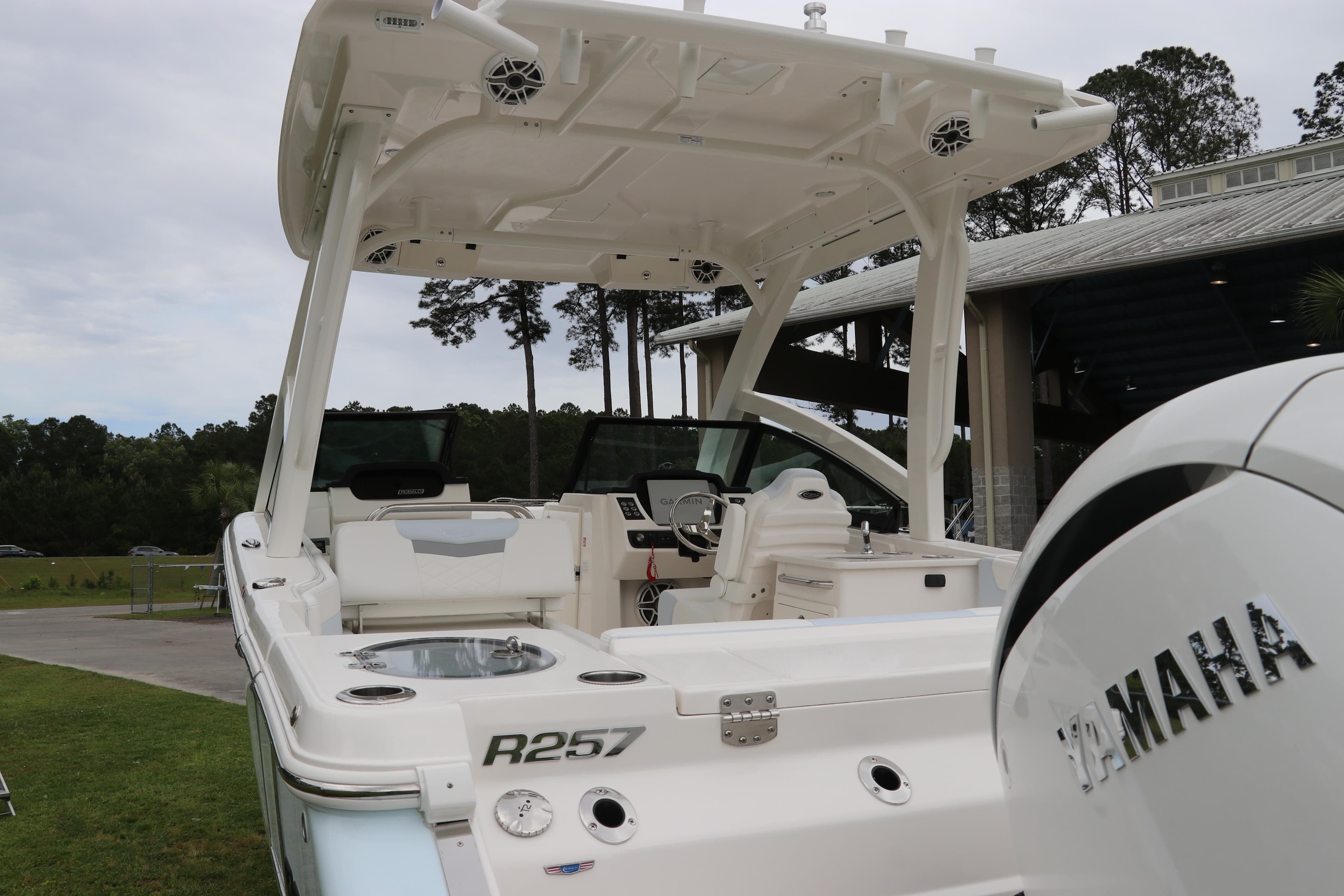 2026 Robalo R257 Dual Console boat with Yamaha engine, docked outdoors.