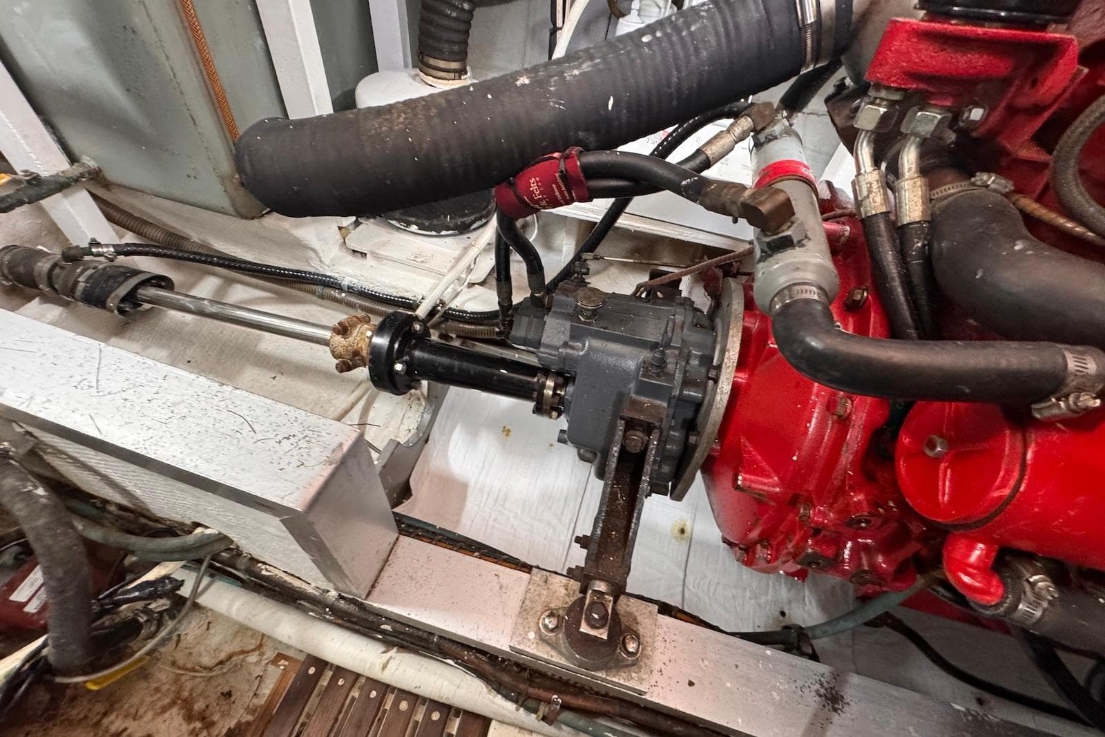 Engine room of 1989 Grand Banks 42 Motoryacht, showcasing mechanical components and hoses.