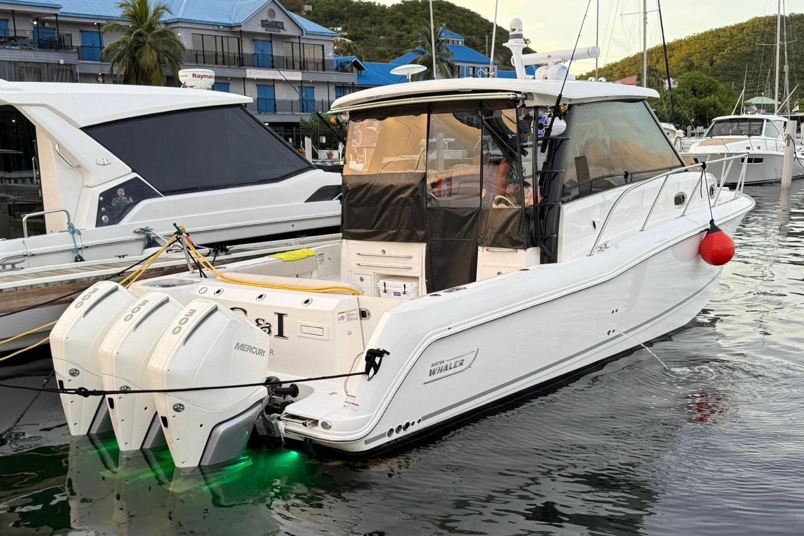 2023 Boston Whaler 345 Conquest boat docked with triple Mercury engines.