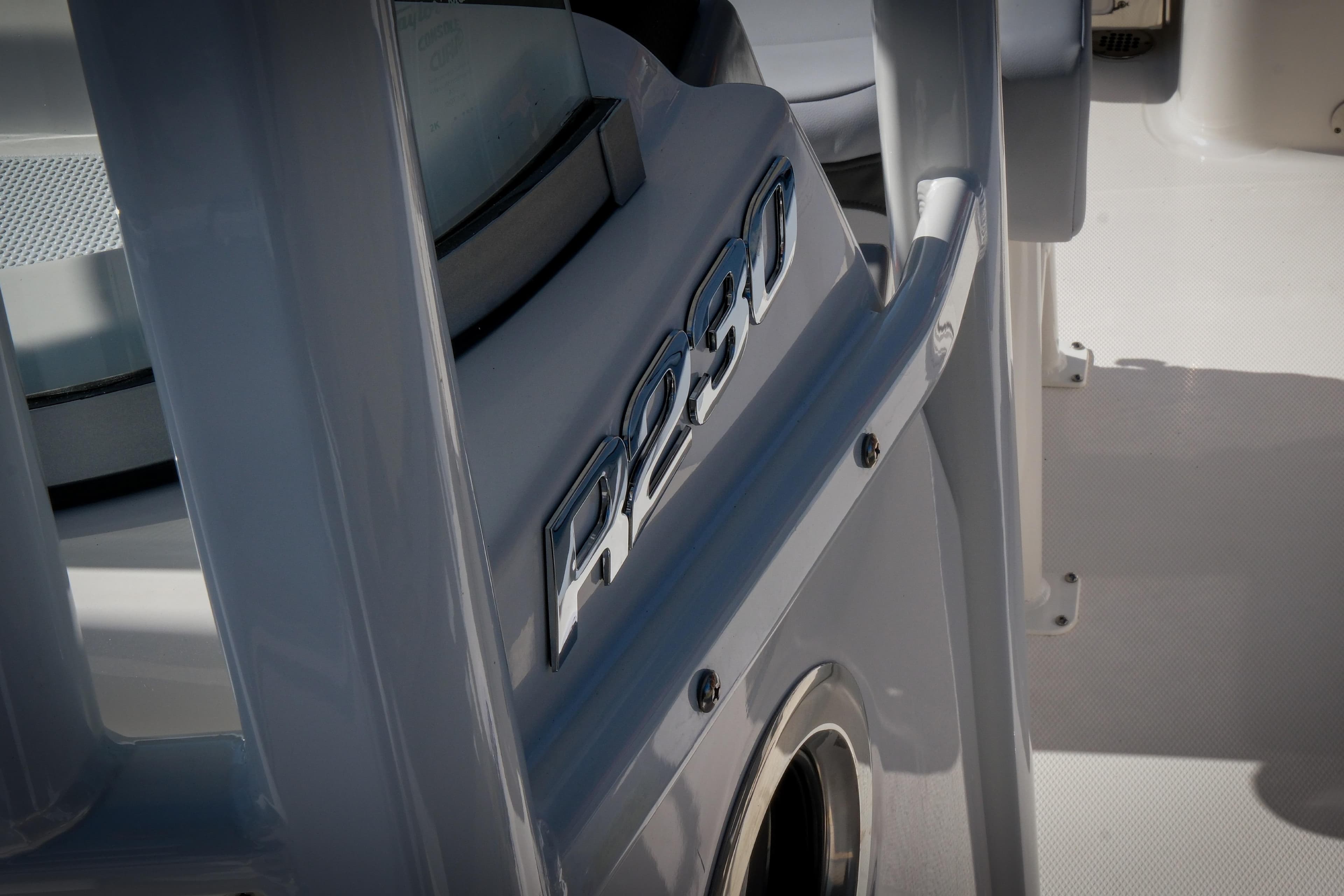 2025 Robalo R230 Center Console boat detail with sleek design and logo.