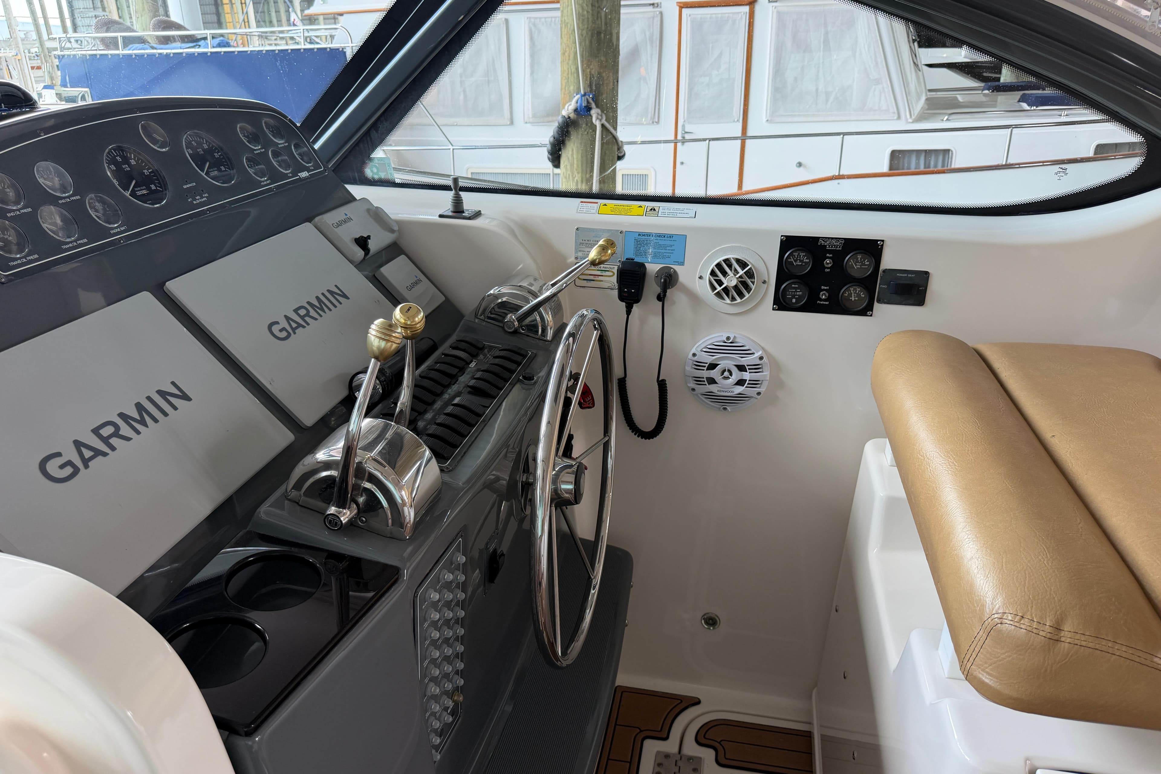 Helm of 2002 Tiara Yachts 3800 Open with Garmin navigation systems and controls.