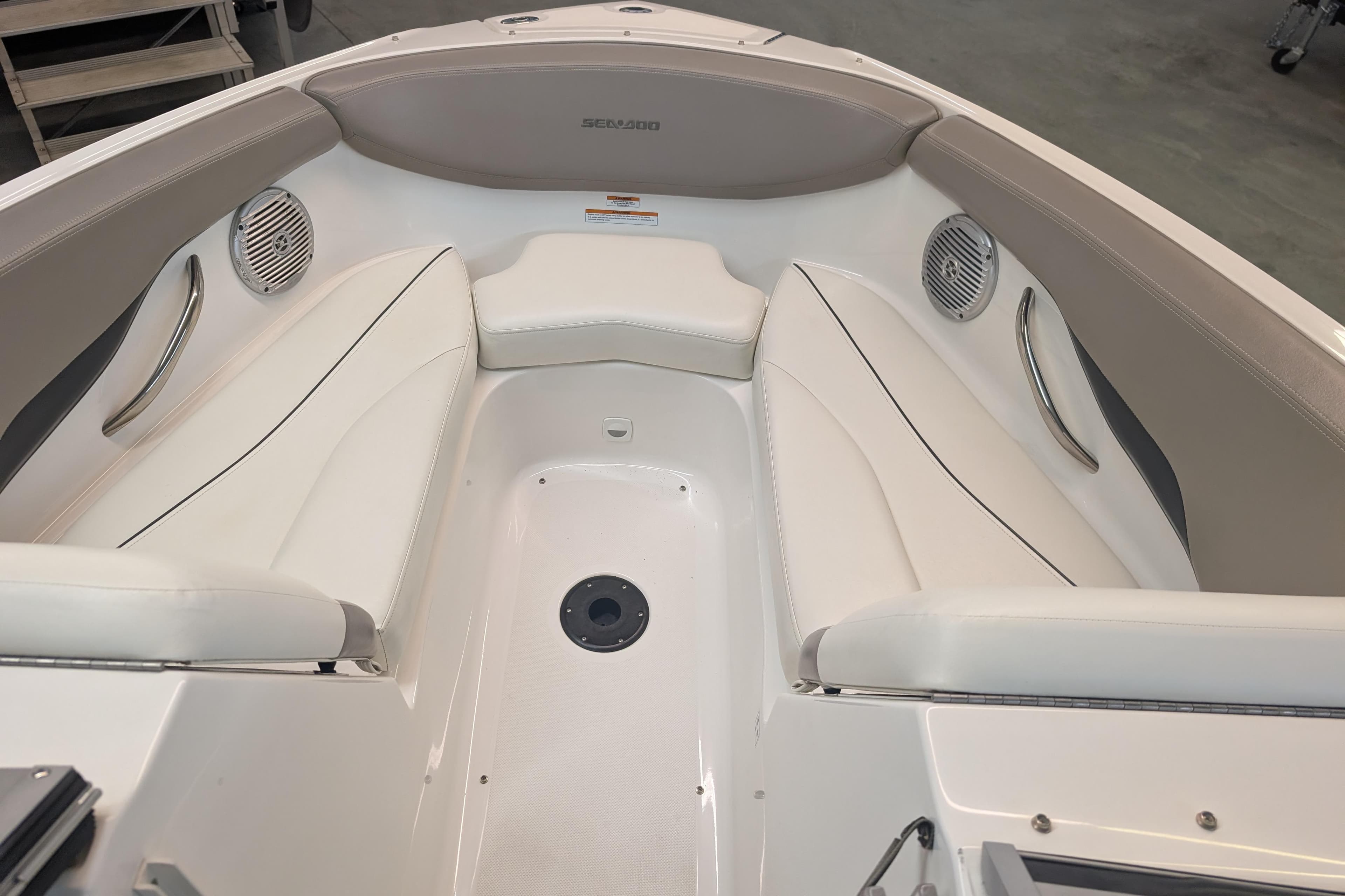 2010 Sea-Doo 210 Challenger SE boat interior with white seating and speakers.