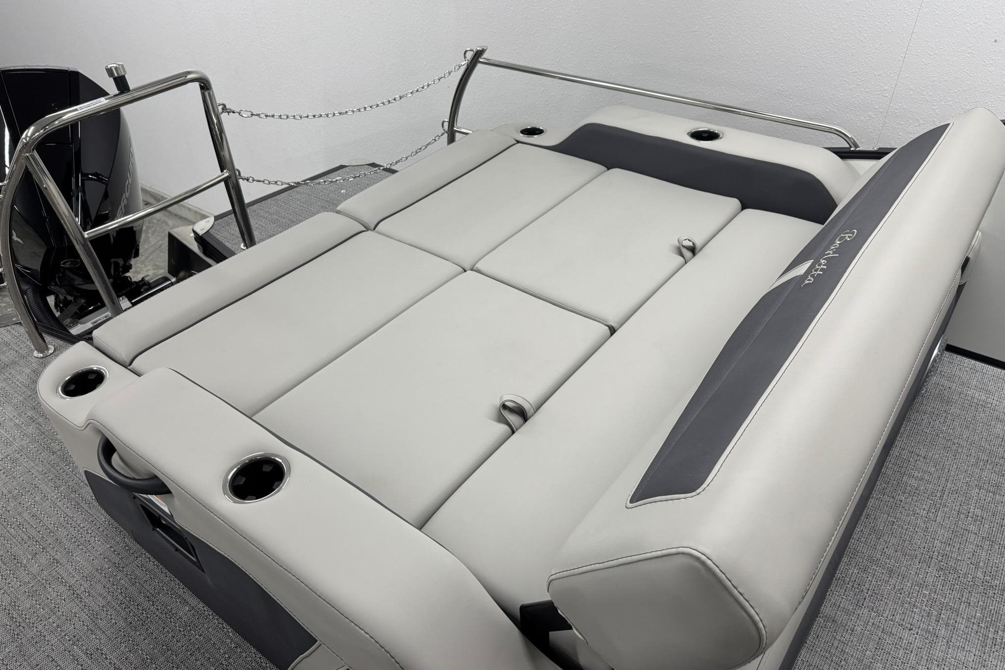 2025 Barletta Cabrio 24UC boat interior with plush seating and cup holders.