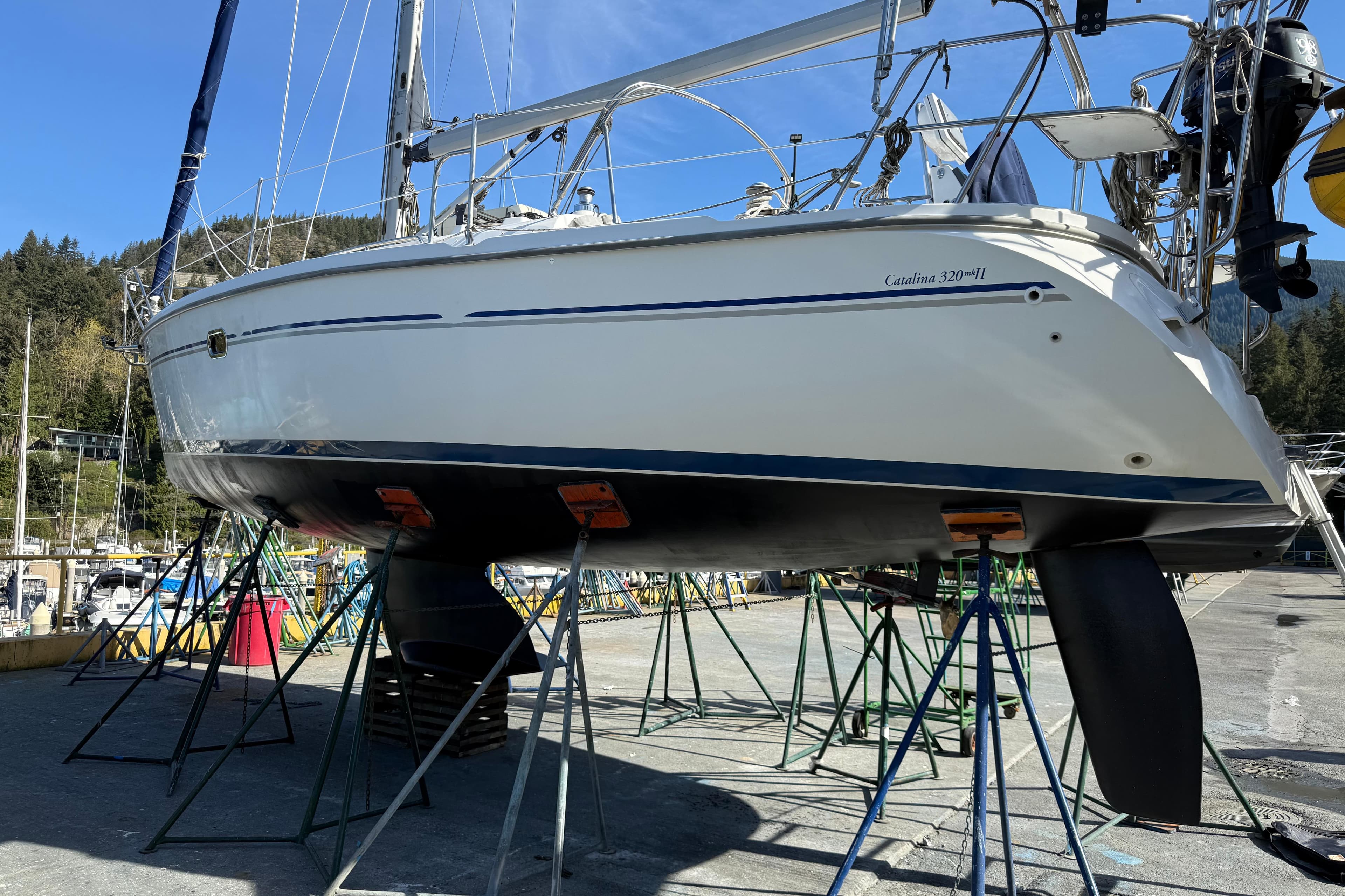 2007 Catalina 320 MkII sailboat on stands in a marina, ready for maintenance.