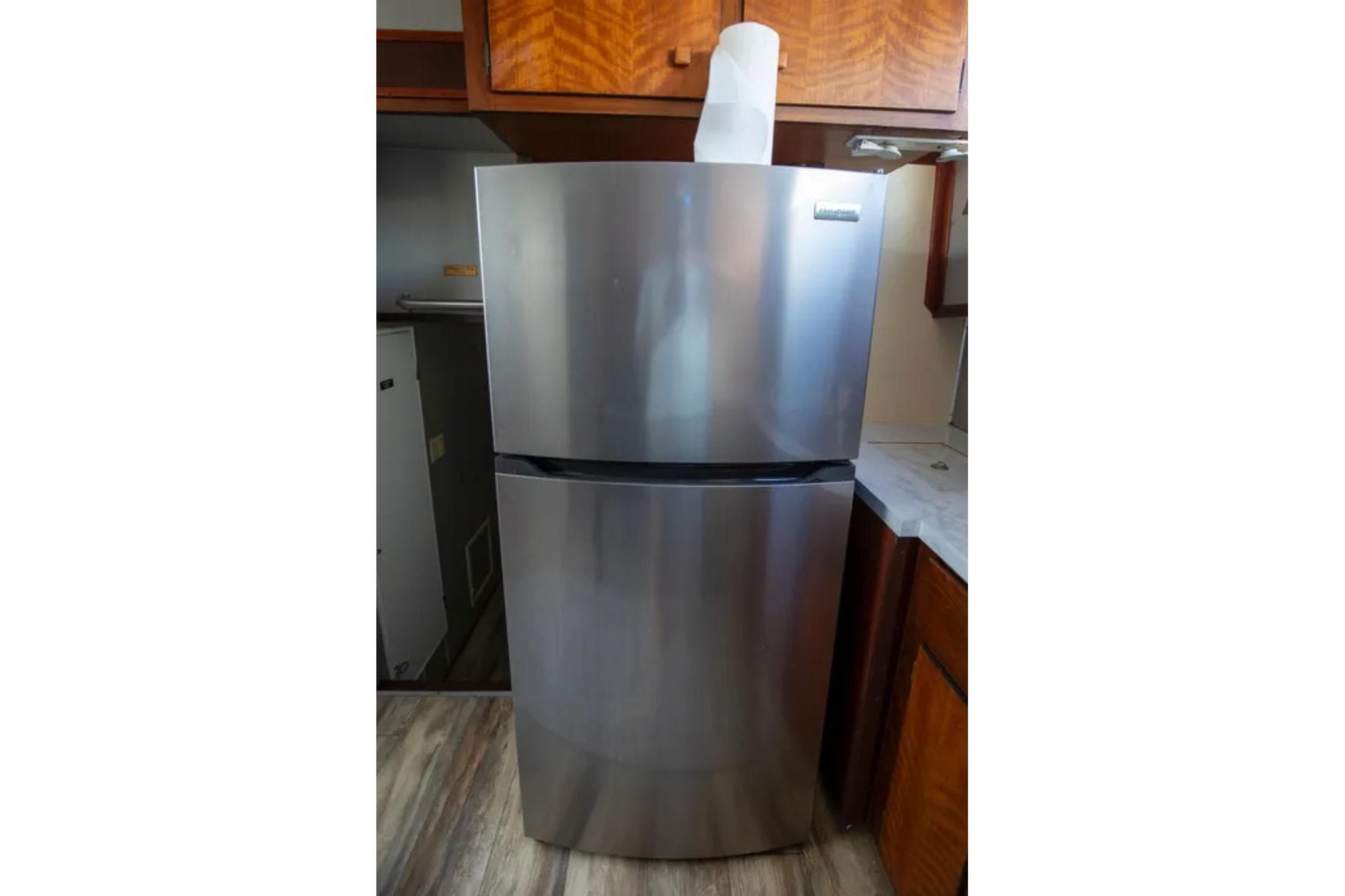 Stainless steel refrigerator in 1973 Hatteras 58 Yacht Fisherman kitchen.
