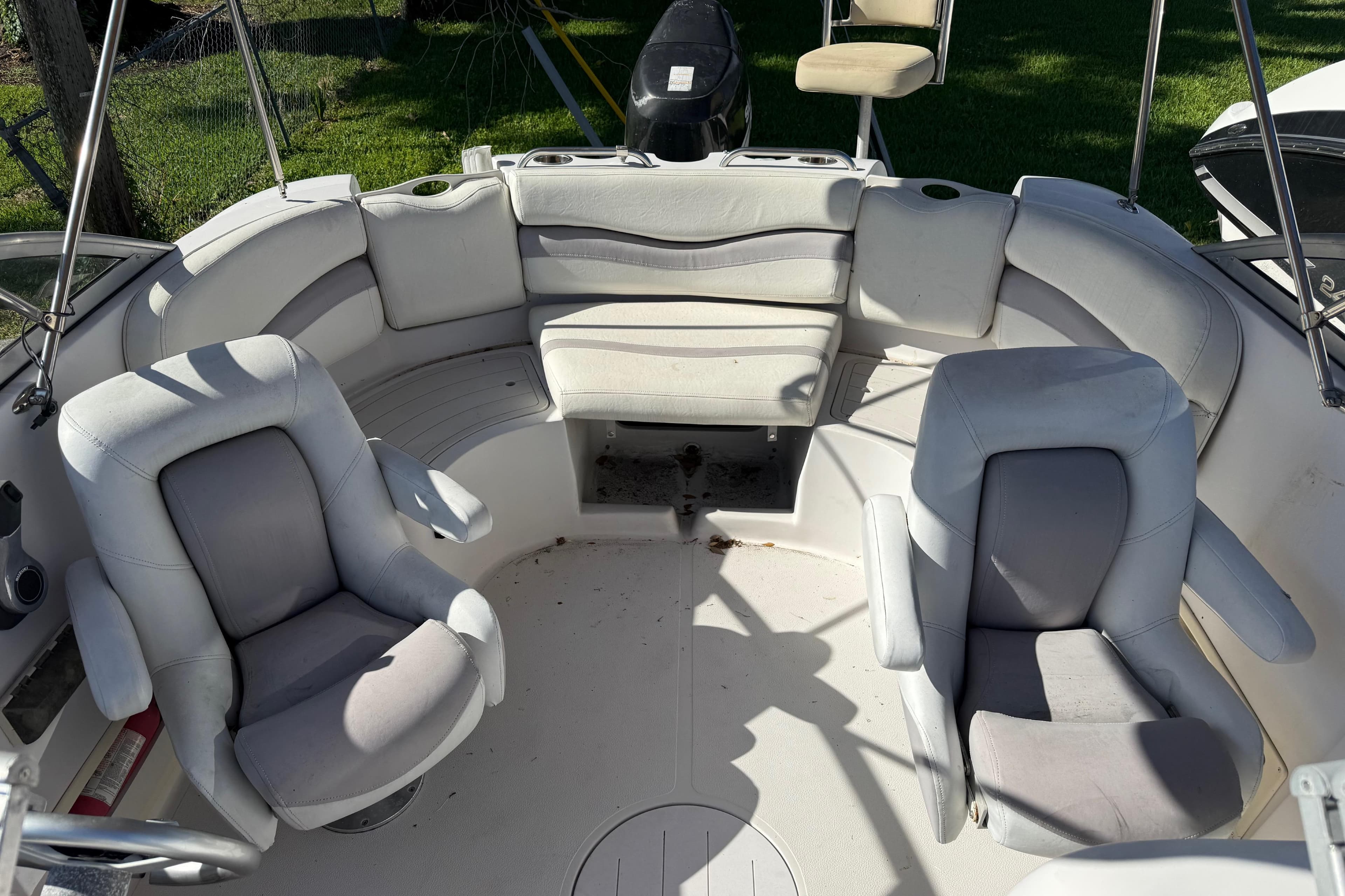 2005 Starcraft Aurora 2210 OB boat interior with white seating and steering chairs.