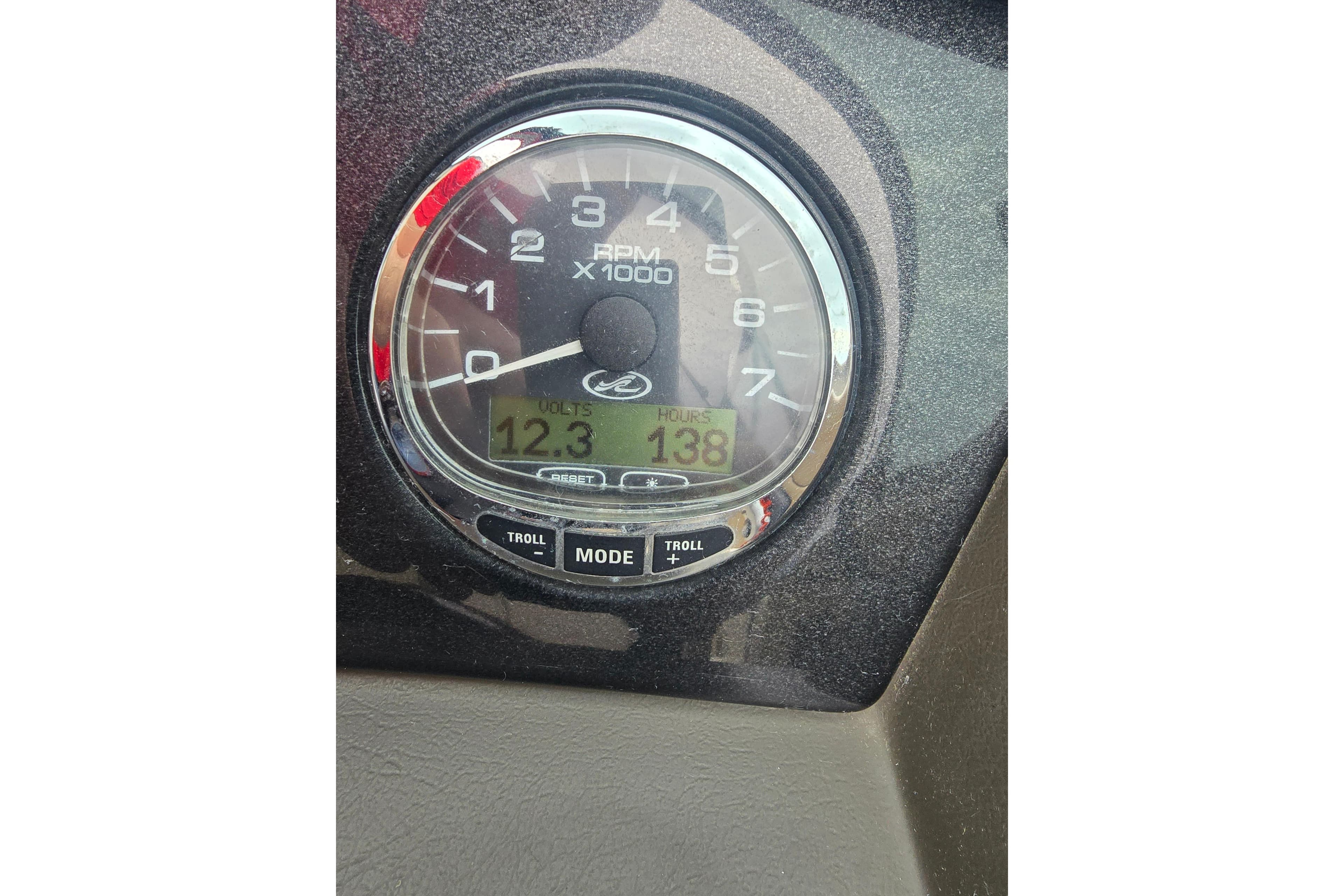 Close-up of a 2007 Sea Ray 210 Select boat tachometer displaying RPM, volts, and hours.