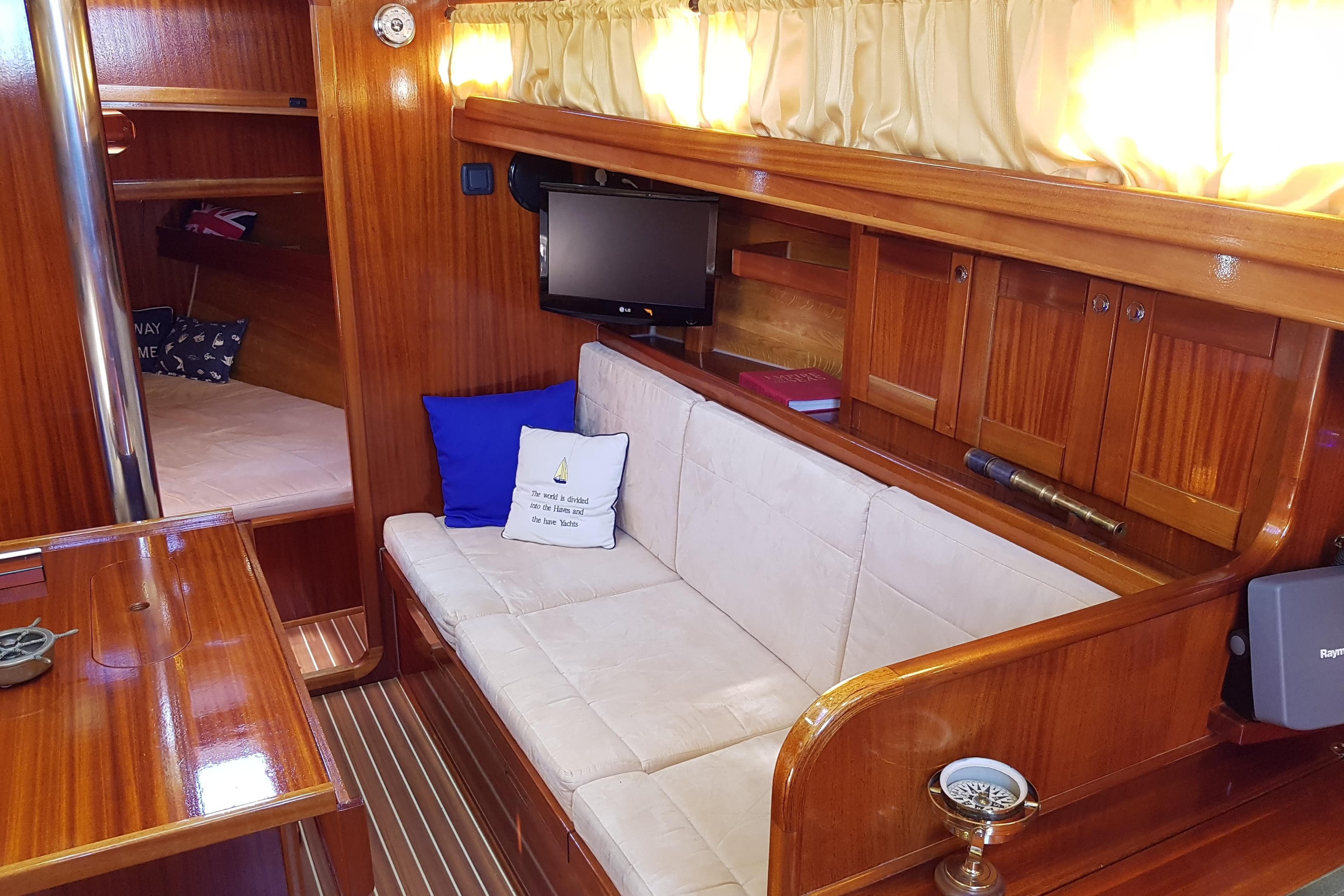 Luxurious 2008 CUTTER ENAVIGO yacht interior with cozy seating and elegant wood finish.