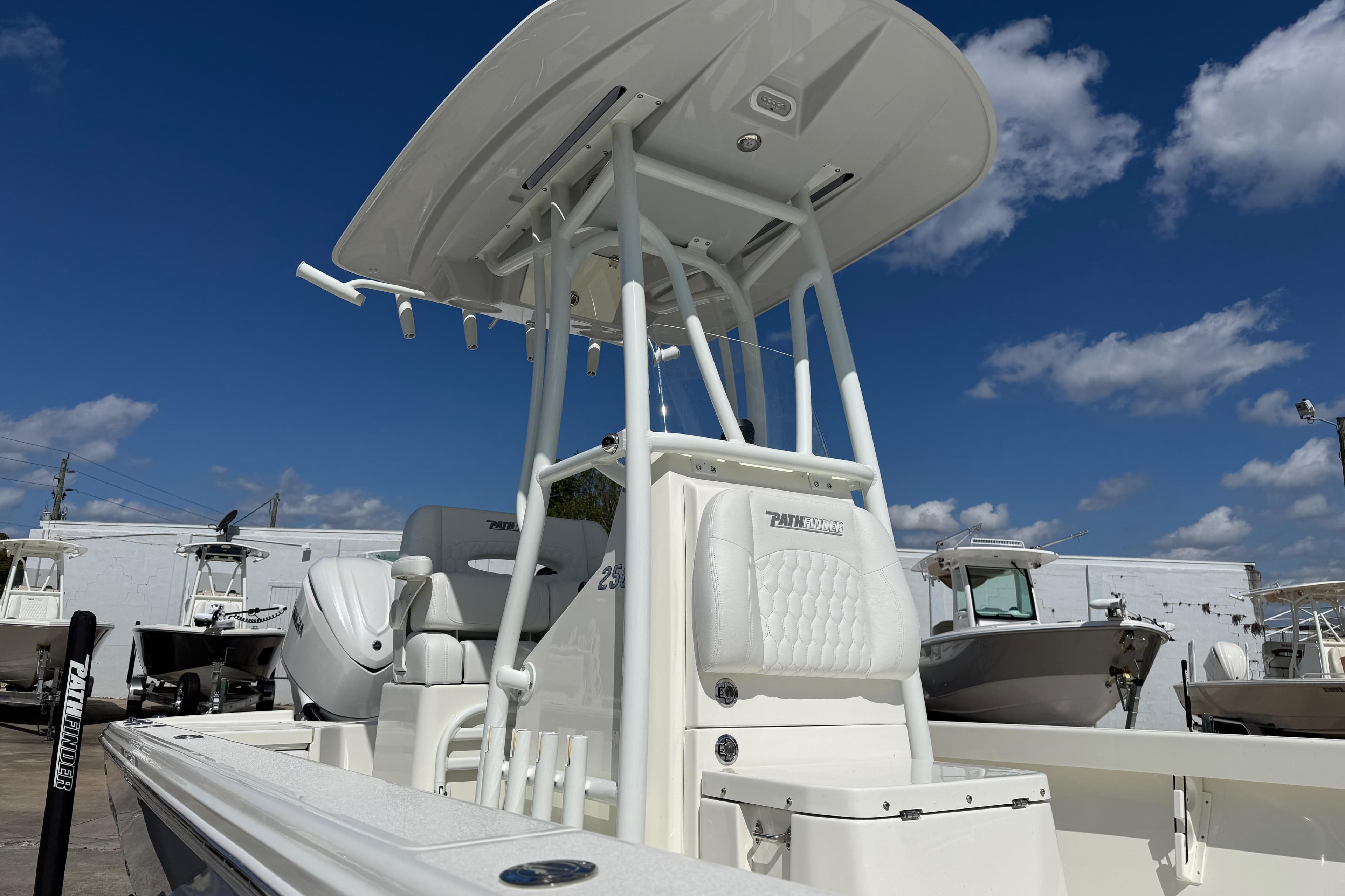2026 Pathfinder 2500 Hybrid boat with T-top under a clear blue sky.