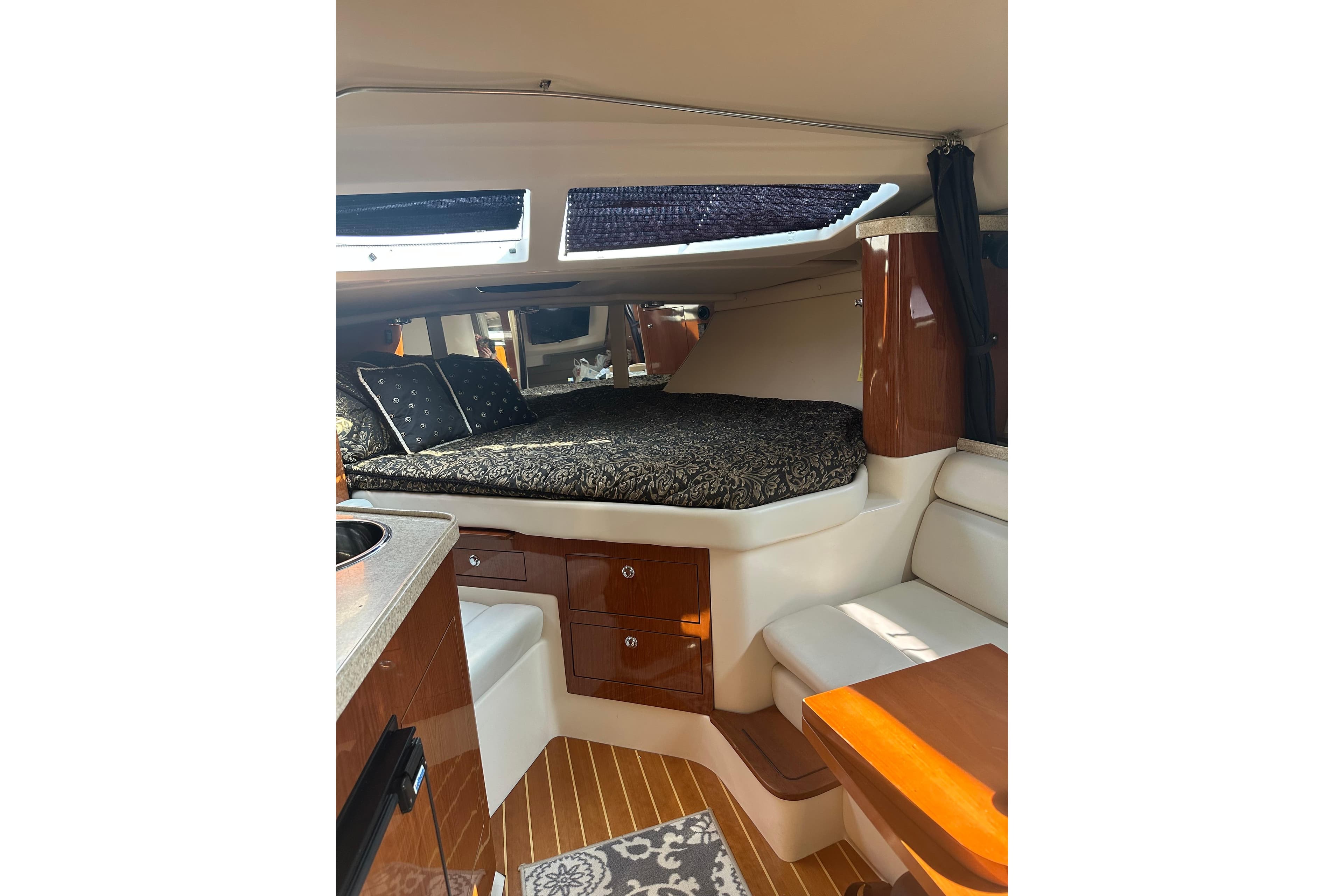 Interior of 2005 Regal 3360 Window Express yacht with cozy bed and seating area.