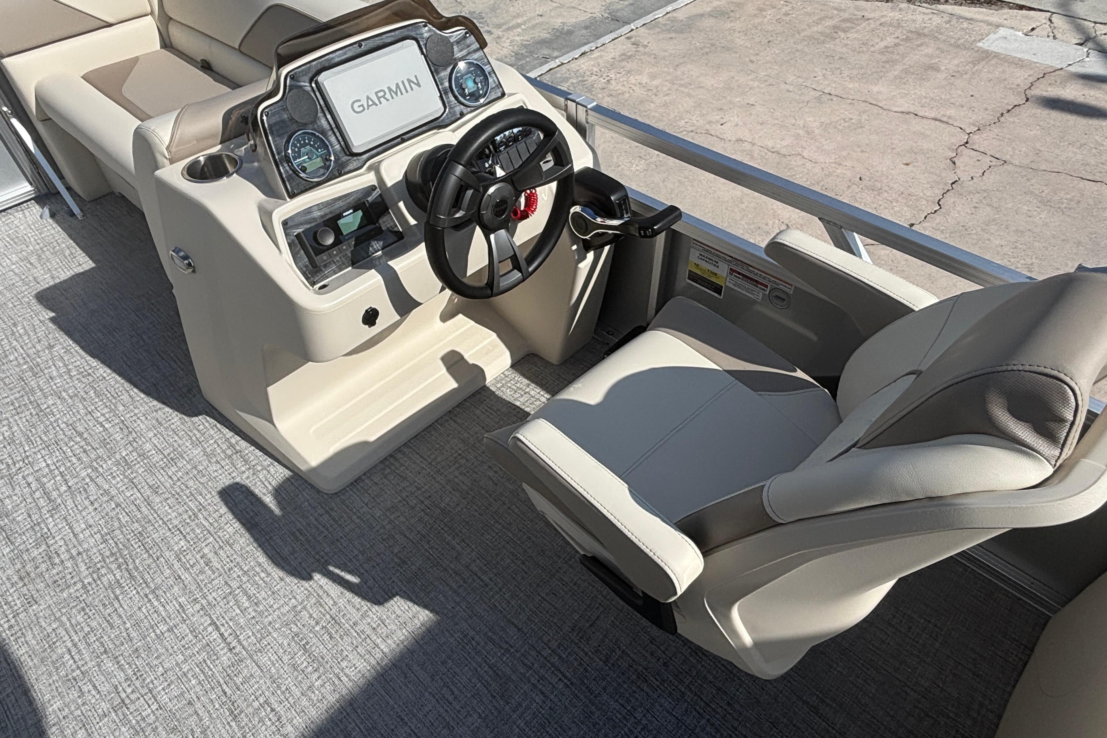 2026 Tahoe Pontoon 21 boat interior with steering console and Garmin display.