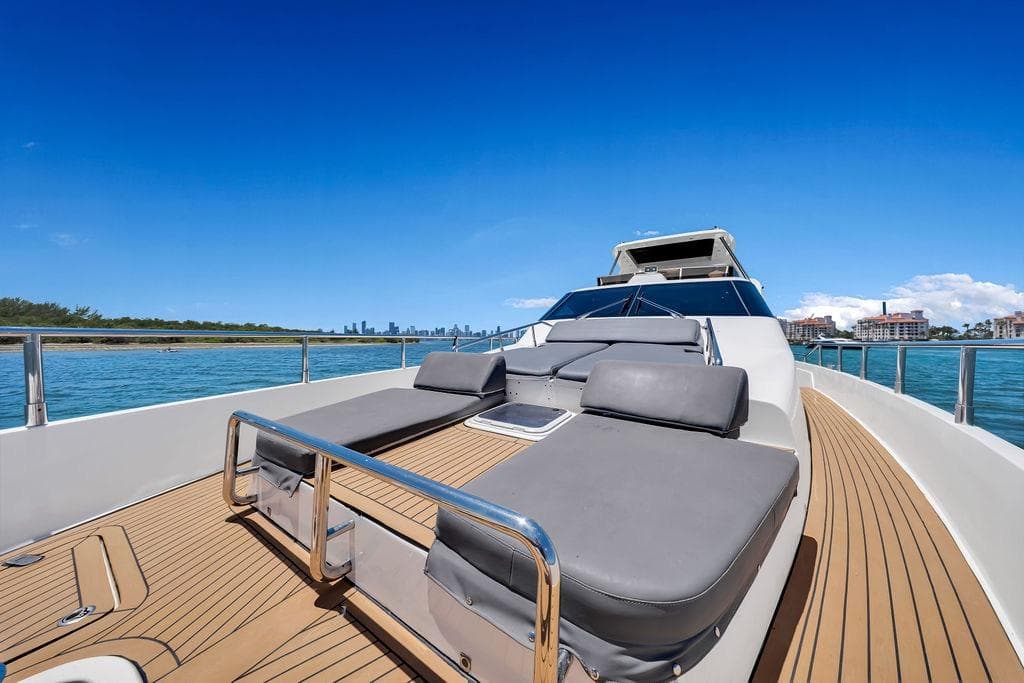 Luxurious 2008 Aicon 75 yacht deck with sun loungers, ocean view, and clear blue sky.
